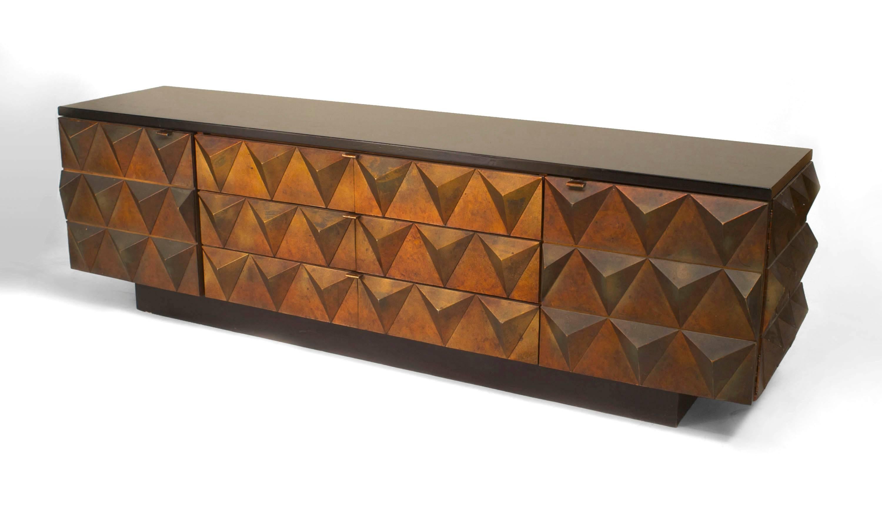 Italian Post-War Design Modernist low sideboard cabinet with copper polychromed pyramid design having 2 doors centering 3 drawers with an ebonized platform base and top.
