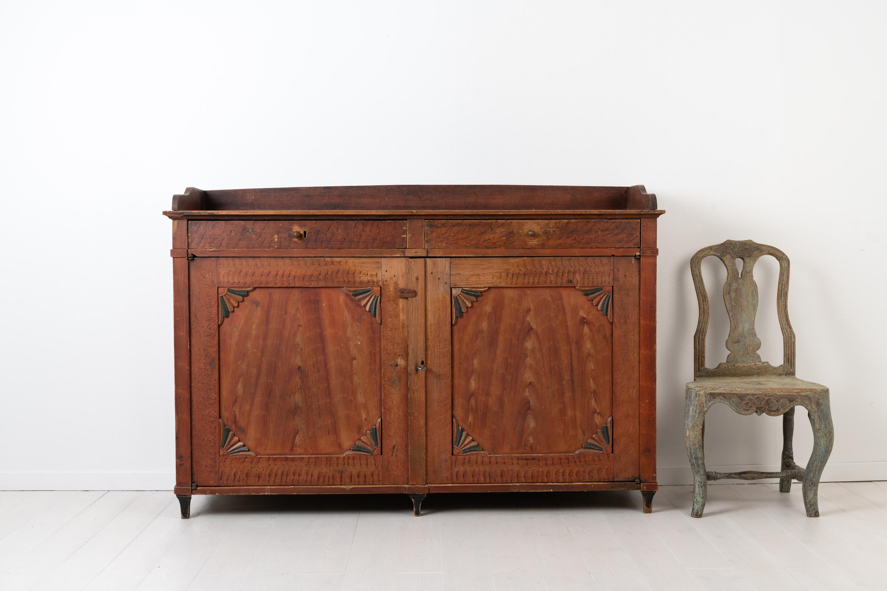 Low red Gustavian sideboard from Northern Sweden made circa 1810-1820. The sideboard is in untouched original condition with original paint from the early 1800s. It is unusually low and wide being 165 cm wide but only just over a meter tall. The