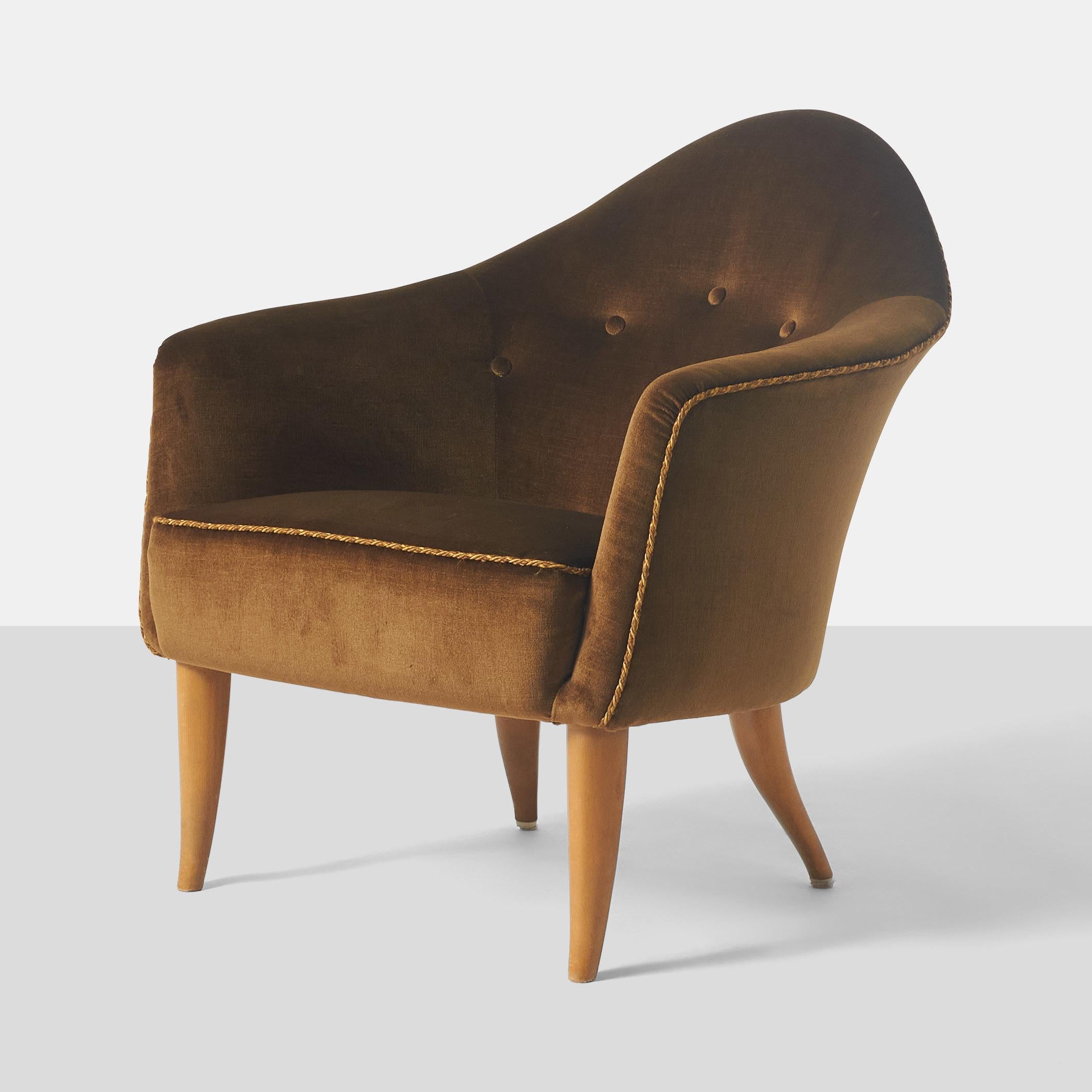 A tufted low back  lounge chair from the Paradise collection by Kerstin Horlin-Holmquist for Nordiska Kompaniet with beech legs and upholstered in a brown fabric and twisted cord trim detail along the seat and back edges. Marked on underside with a