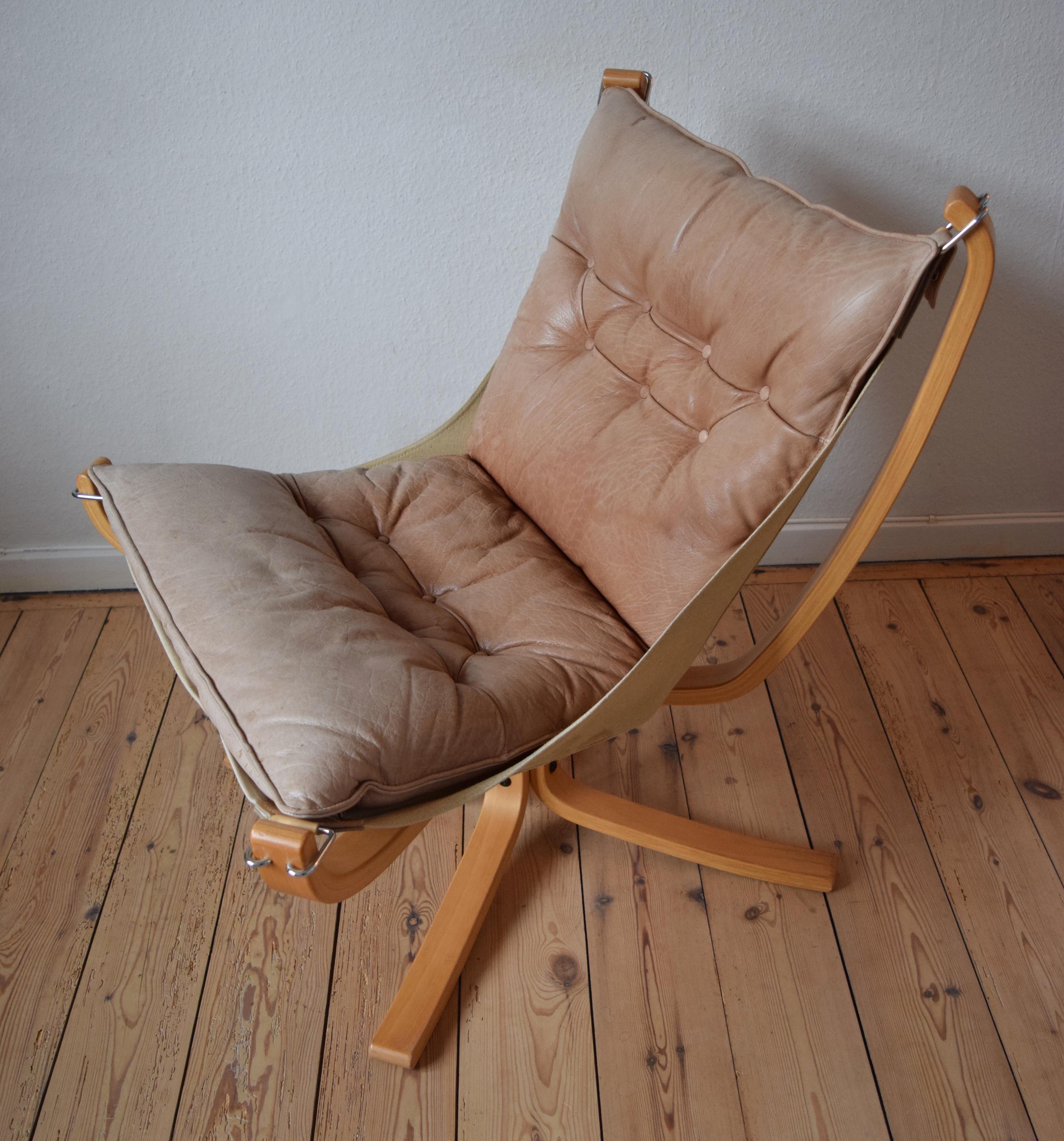 Falcon chair designed by Sigurd Ressel and manufactured by Vatne Møbler in Norway in the 1970s. Features light cognac leather cushion and sits on a canvas hammock. Bent beechwood legs. The leather is in great shape and is still soft and supple.