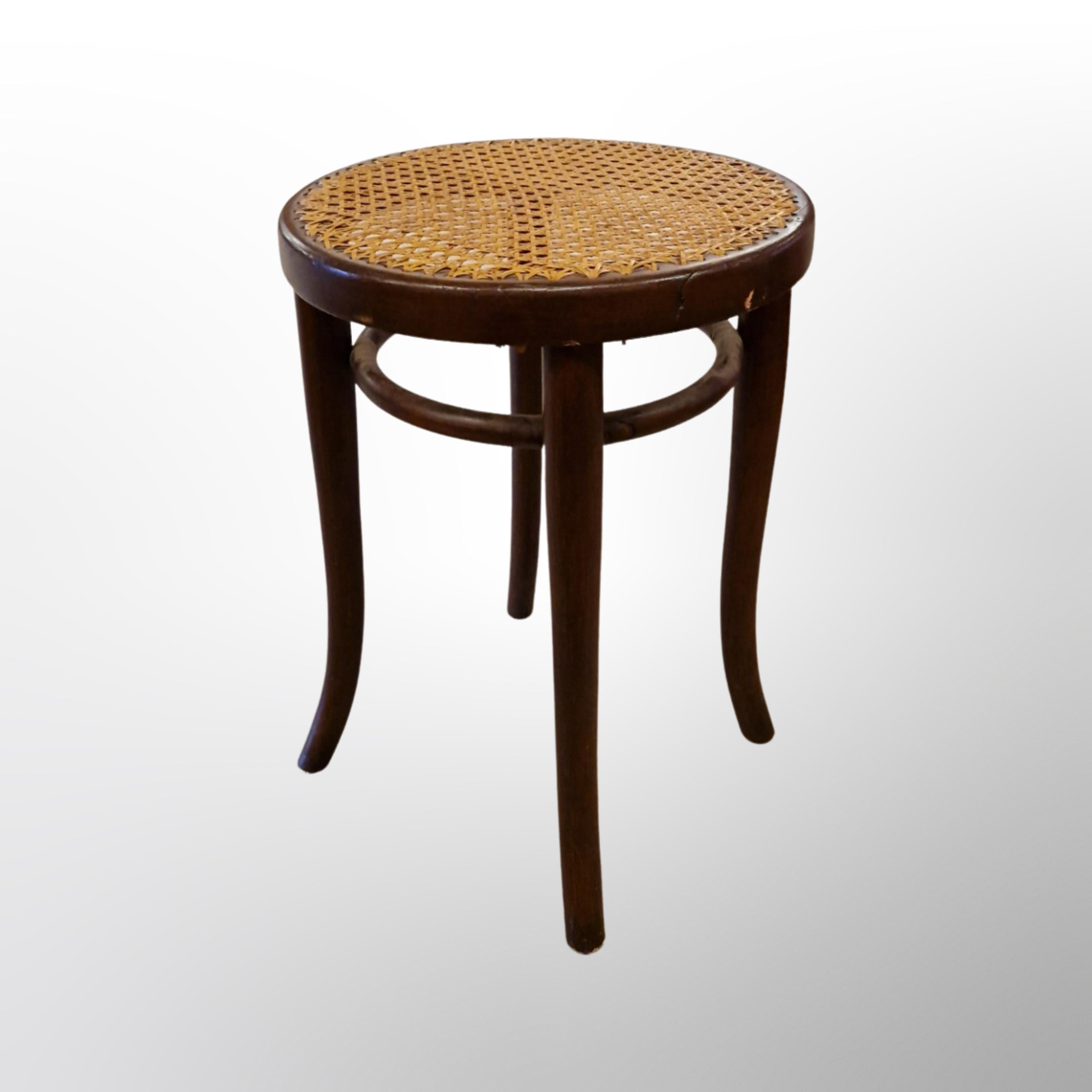 Original low stool. Made from bentwood and woven cane. Made by Thonet in the 1950s. Stamped with the Thonet name underneath. 
