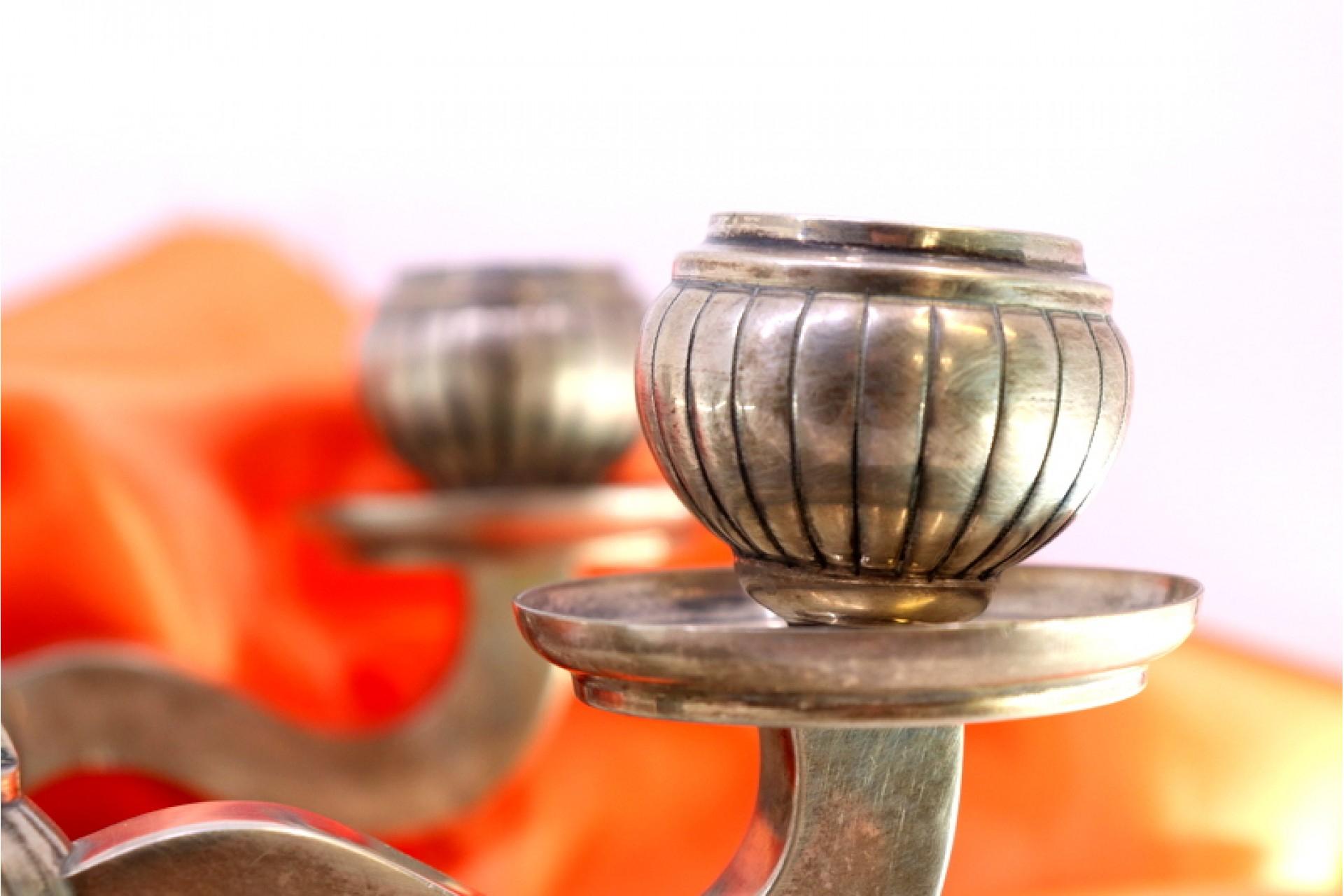 Description: Low candelabra with two lights and gradient bases. Metal: Silver. Origin: Portuguese. Mark: standing eagle. Weight: 752.87 grams. Dimensions: 22cmx10.5cm. Content: 833/1000. Assay Mark: Yes, between 1938 and 1984. Additional