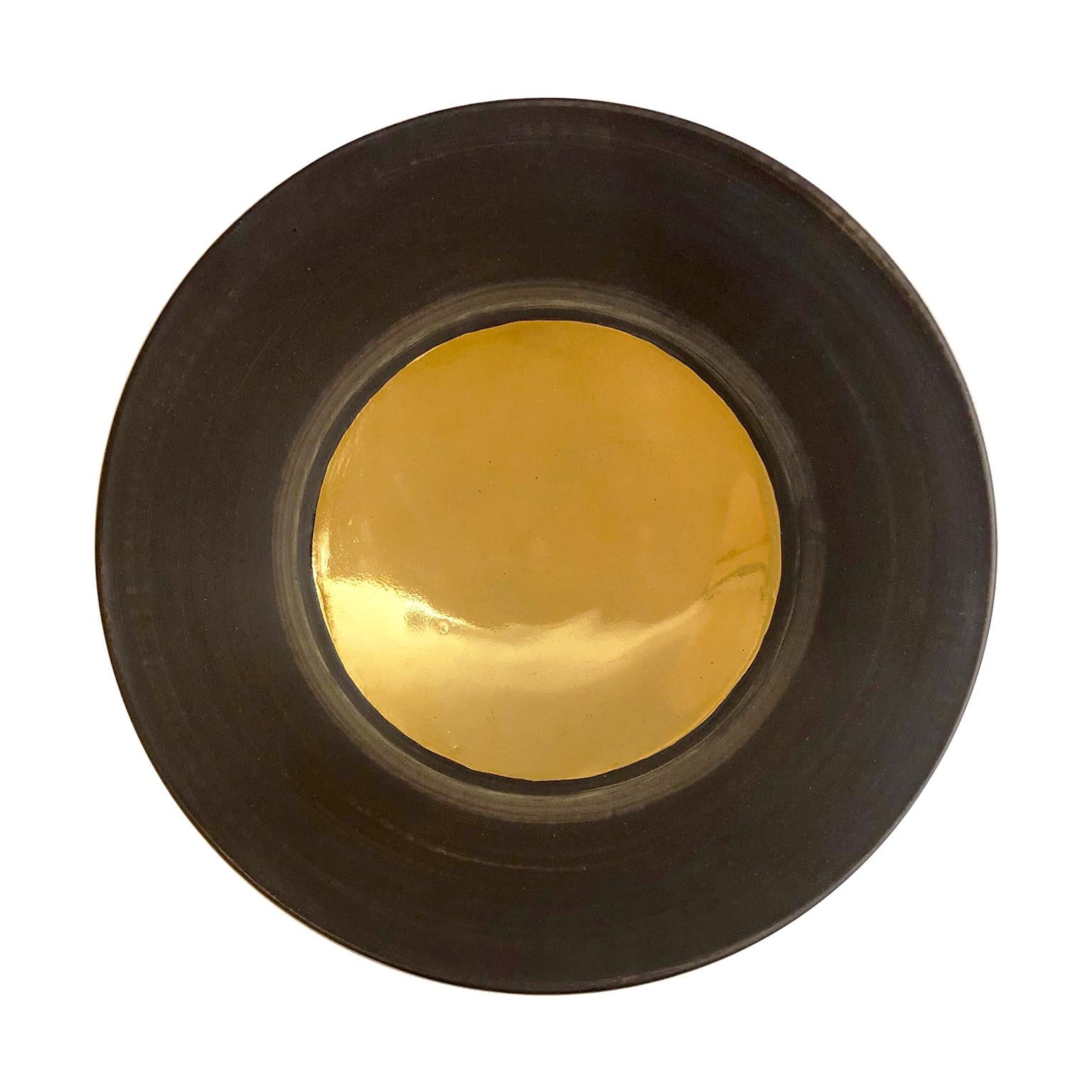 Low ceramic bowl with rust glaze and 22-karat gold lustre interior by Sandi Fellman, 2019. 


Veteran photographer Sandi Fellman's ceramic vessels are an exploration of a new medium. The forms, palettes, and sensuality of her photos can be found
