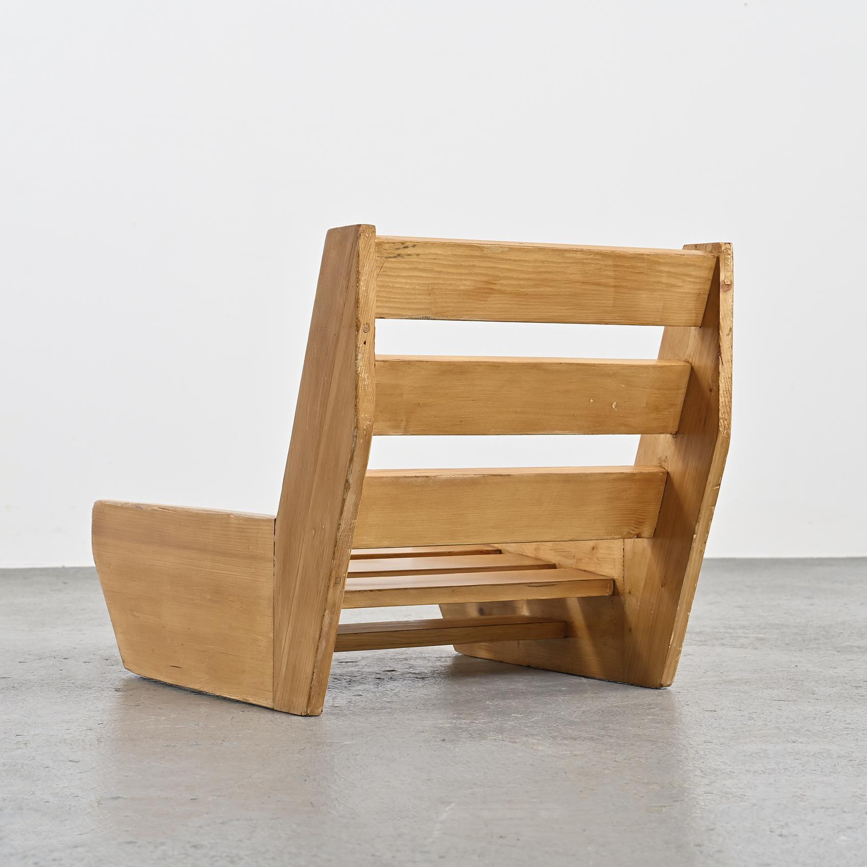 Low armchair with a solid pine frame, featuring slatted seat and backrest, designed by René Martin, known as René les Ciseaux, a cabinetmaker who collaborated with Charlotte Perriand for many years.

Provenance: Chalet located in Les Allues,