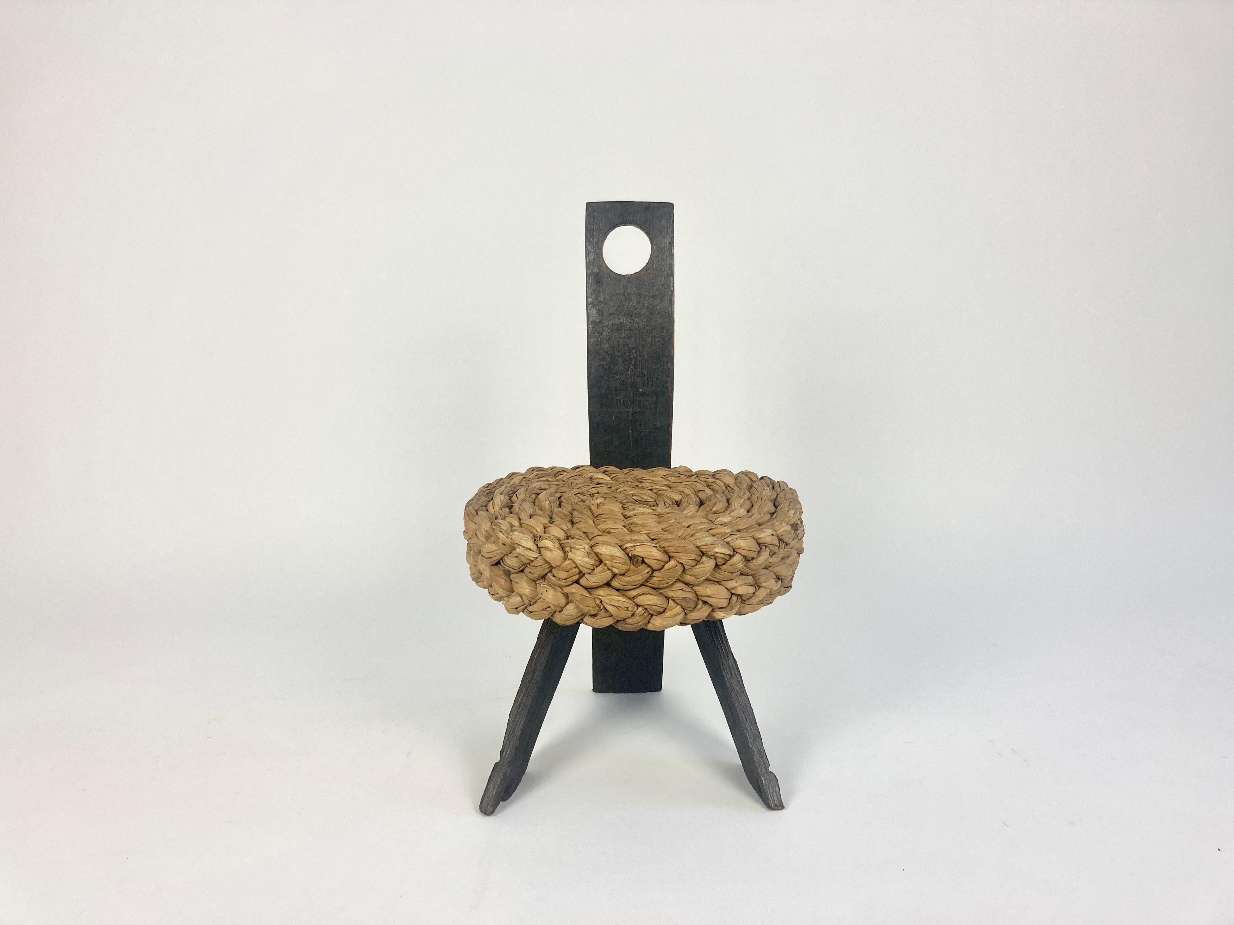 Low stool  by French designers Adrien Audoux and Frida Minet. France, 1950s.

The seat is made of thick reed braids woven in a circular pattern. Legs and back rest are made of dark oak which perfectly contrasts the seat. The chair has a wonderful