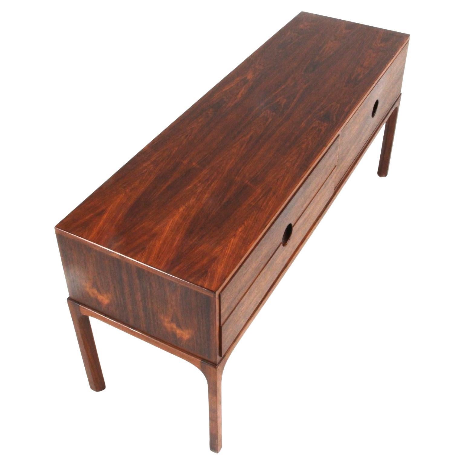 Low chest with 4 drawers signed by the great Danish designer Kai Kristiansen and made by the cabinetmaker and designer Aksel Kjersgaard. In his designs, Kristiansen places a strong emphasis on elegance and refinement, which are perfectly reflected