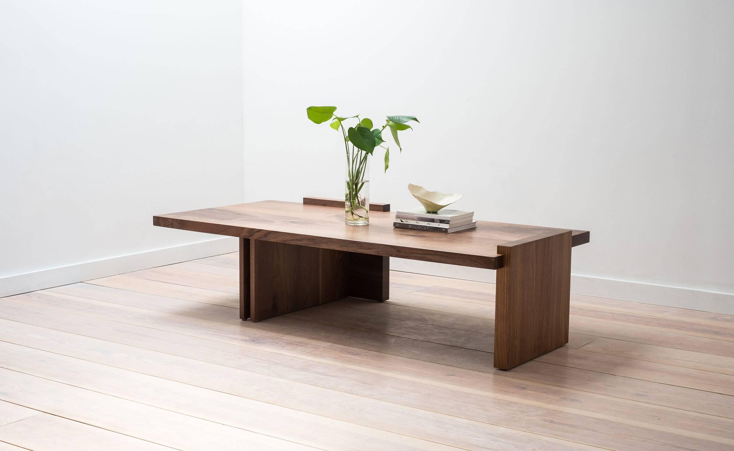 Inspired by the cantilevers of modernist architecture, this contemporary coffee table showcases a minimal geometric form and the highest quality of hand-selected black walnut, sourced on the American east coast. This piece is made by hand in