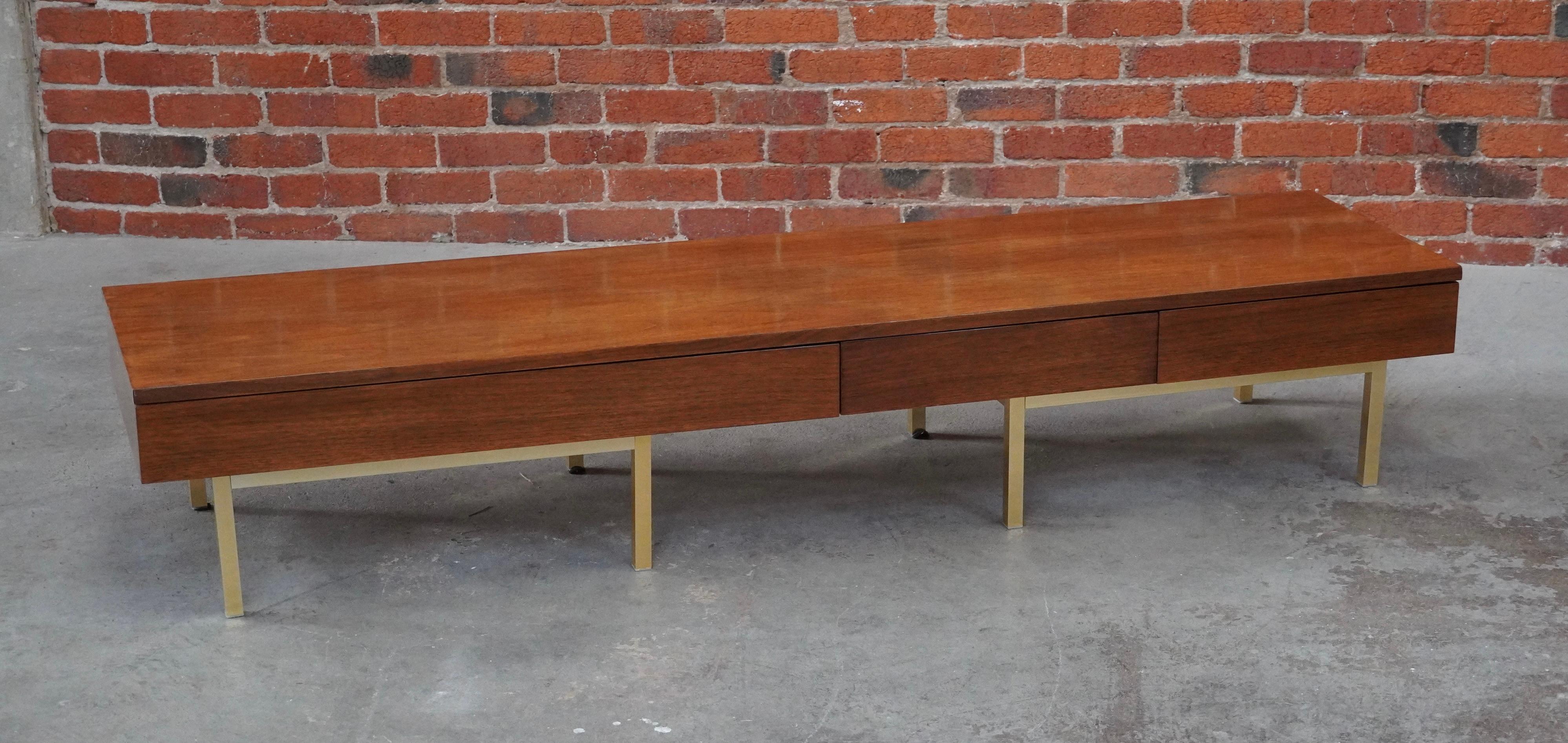Low console with drawers that can also be used as a boxy coffee table or bench. Constructed of walnut with brass anodized legs and three flush drawers for a clean seamless design. Figurative graining to the walnut top.