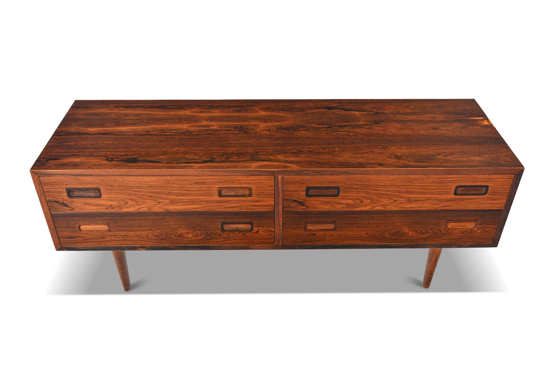 Origin: Denmark
Designer: Carlo Jensen
Manufacturer: Hundevad + Co.
Era: 1960s
Materials: Rosewood
Measurements: 54.5? wide x 17? deep x 21? tall, Drawers, 25? wide x 15? deep x 4.5? tall

Condition: In excellent original condition with some