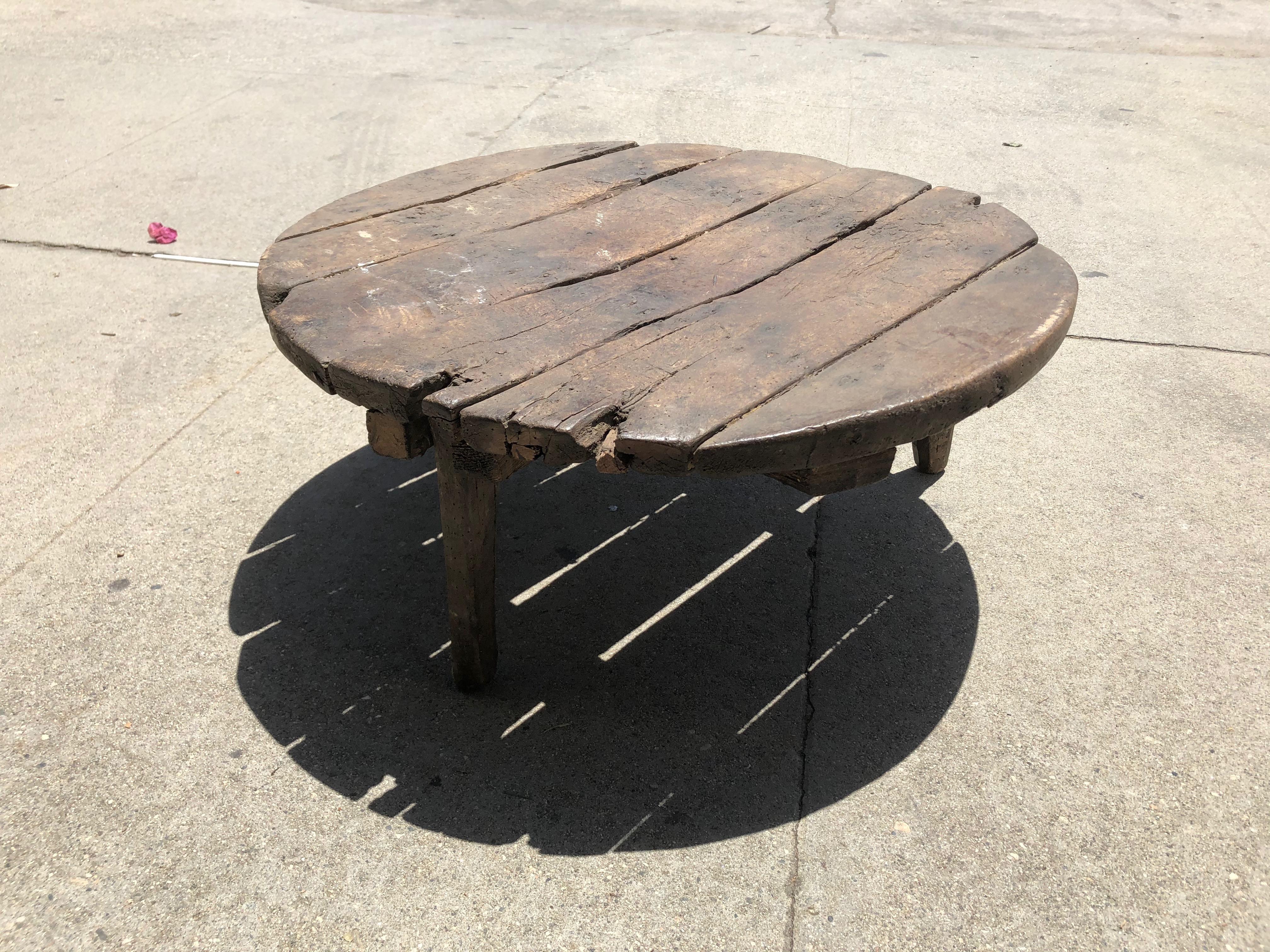 Vintage coffee table made of wood, measures at 12 inches high and 29 inches in diameter.