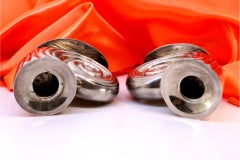 Low fluted silver candlesticks shaped like snails on oval bases