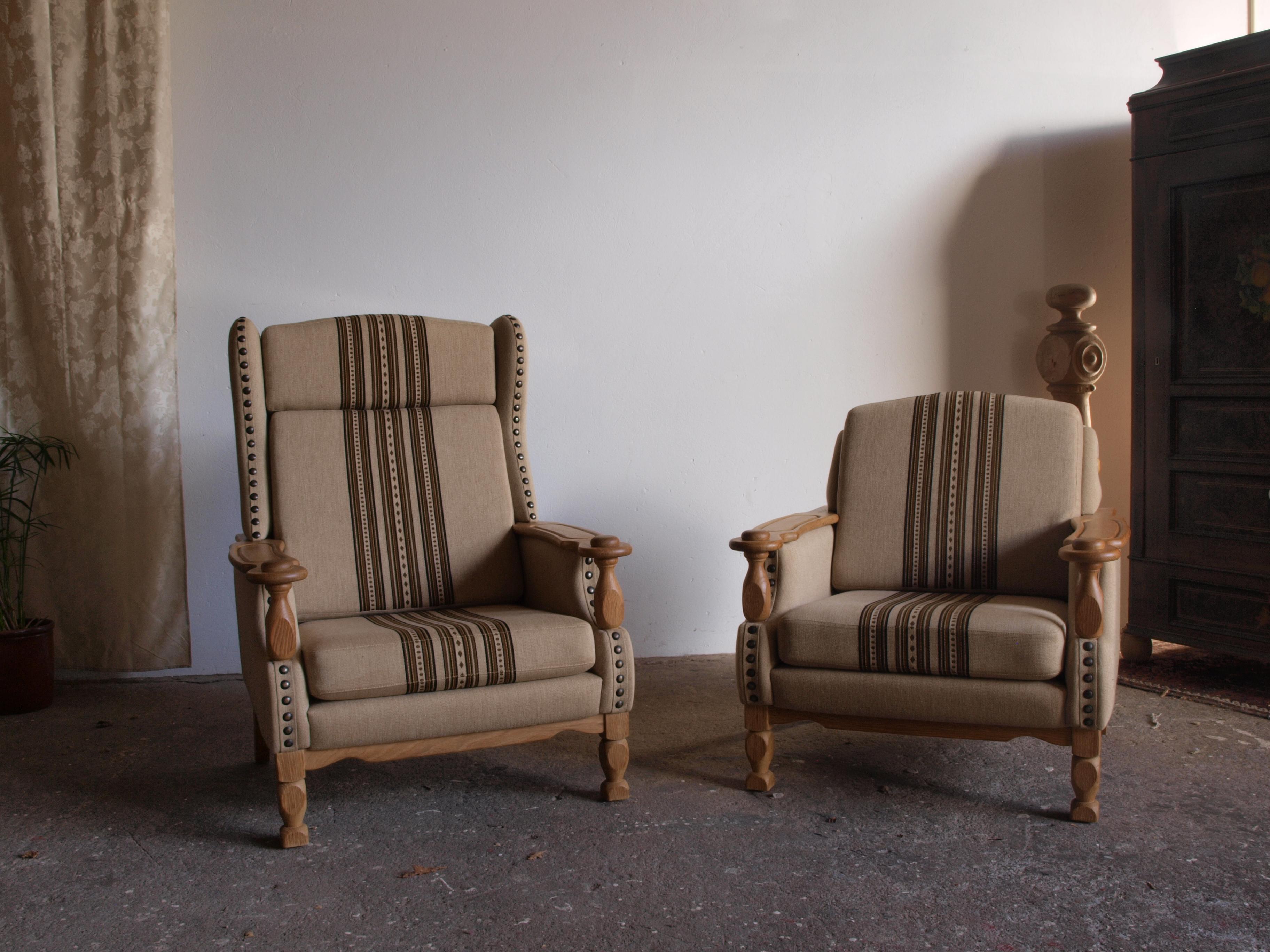 An beautiful set of Danish lounge chairs, resembling the style of Henning Henry Kjærnulf, forms a rare sculptural find. These chairs, crafted from oak and retaining their original savak wool upholstery. Created by an unknown Danish