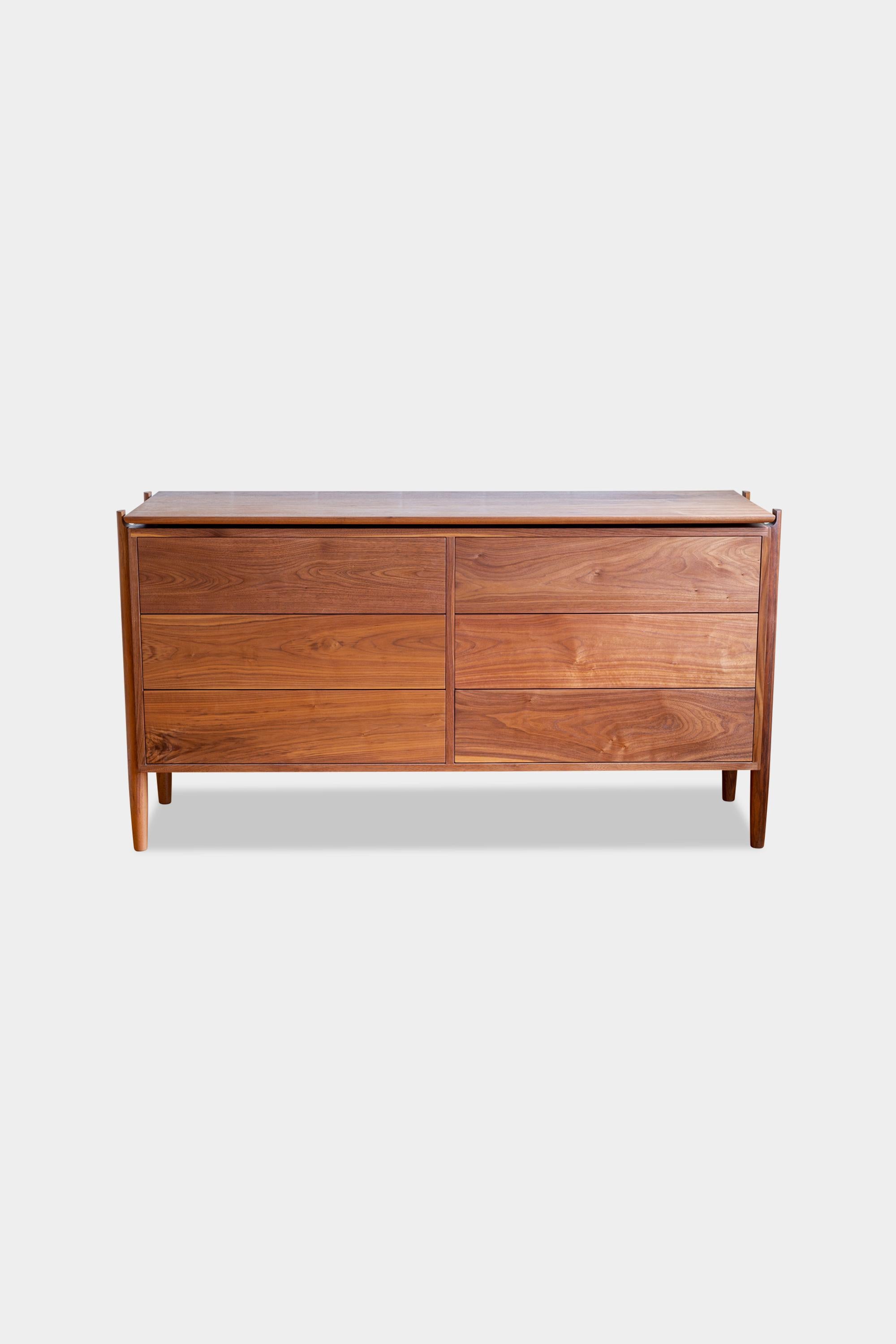 Solid wood constructed sideboard cabinet featuring hand-turned legs, hand-cut joinery and adjustable shelves. It details 6 push-to-open, soft-close drawers in two columns of three. There are custom configurations available, including hand loomed