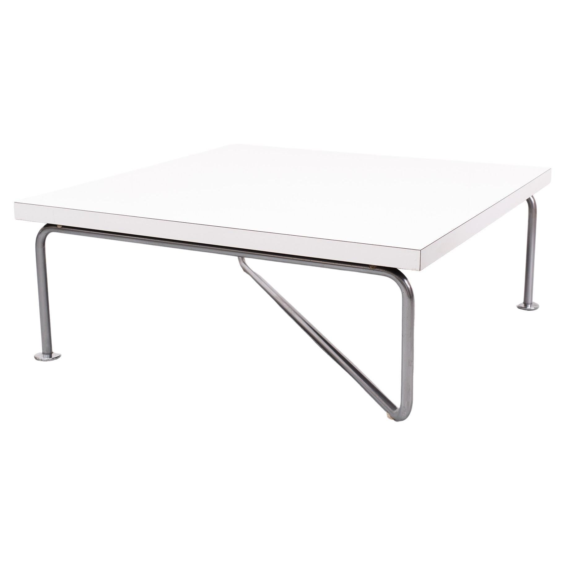 Unique and beautiful low coffee table. Thick White  Laminated top .                                        Very unusual Designed nickel tube base diagonal  placed.

Please don't hesitate to reach out for alternative shipping quote  
  