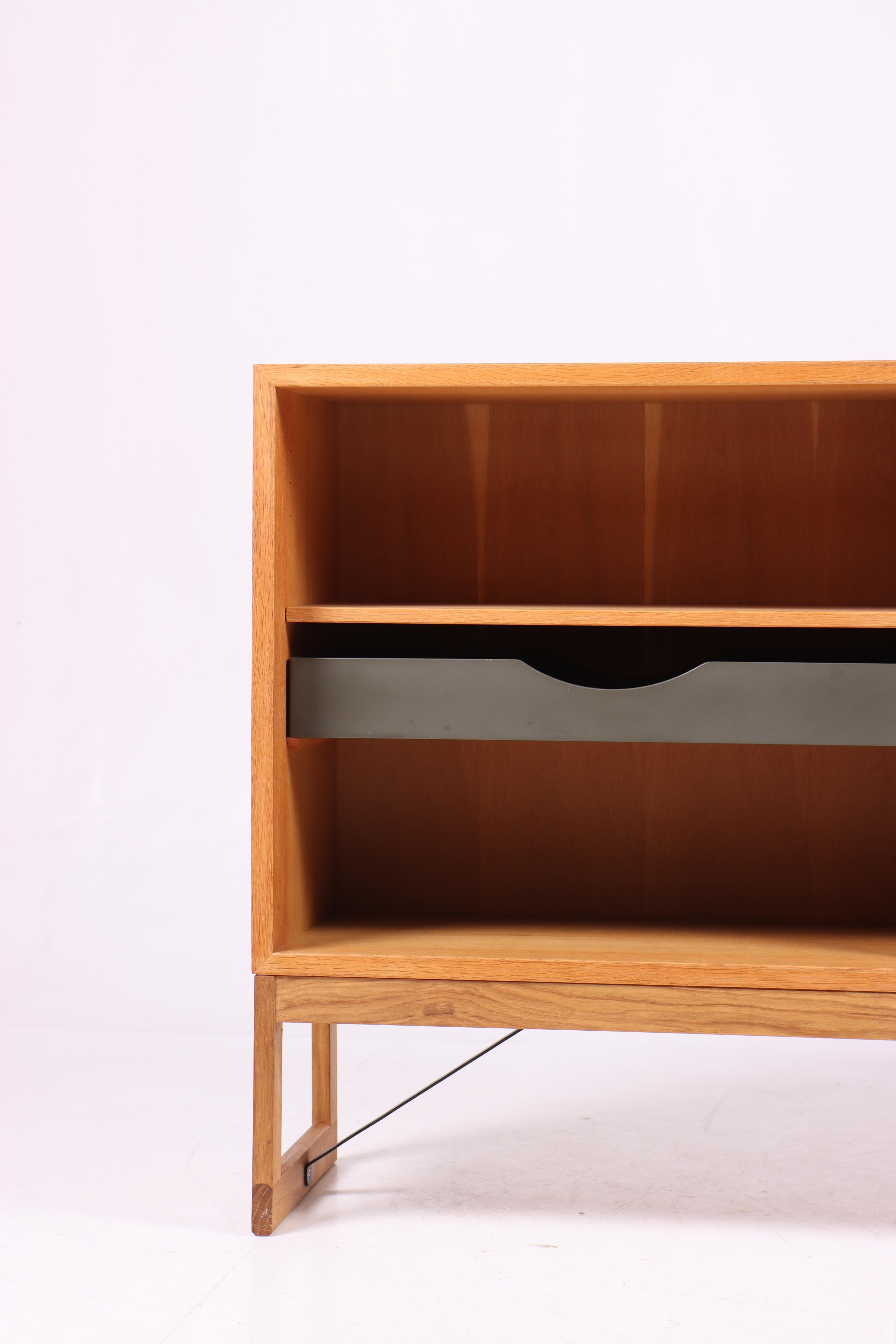 Low bookcase in oak with adjustable shelves and colored drawers. Designed by Danish architect Børge Mogensen for Karl Andersson cabinetmakers. Made in Sweden in the 1960s. Great original condition.