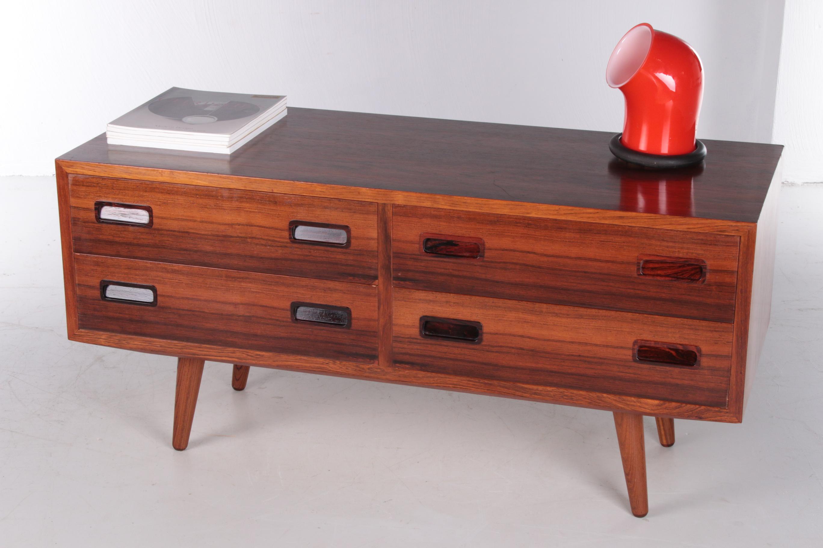 This low sideboard with four drawers is a must have in your living room and is quintessential Hundevad & Co.

Very functional, made with an eye for detail and with high-quality materials.

It is the perfect match between form and