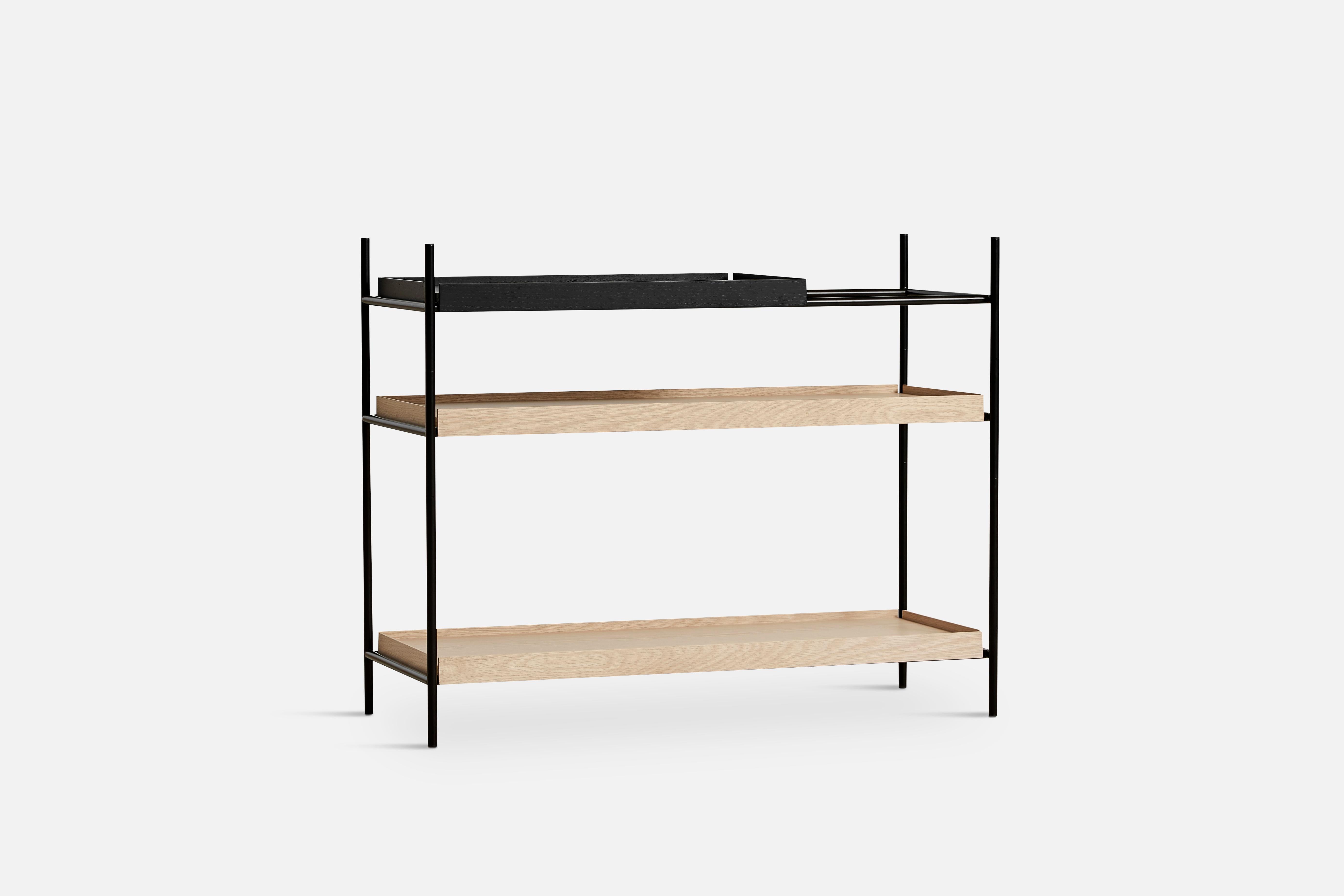 Low oak and black tray shelf I by Hanne Willmann
Materials: metal, oak.
Dimensions: D 40 x W 100 x H 81 cm
Also available in different tray conbinations and 2 sizes: H81, H 201 cm.

Hanne Willmann is a dynamic German designer with her own