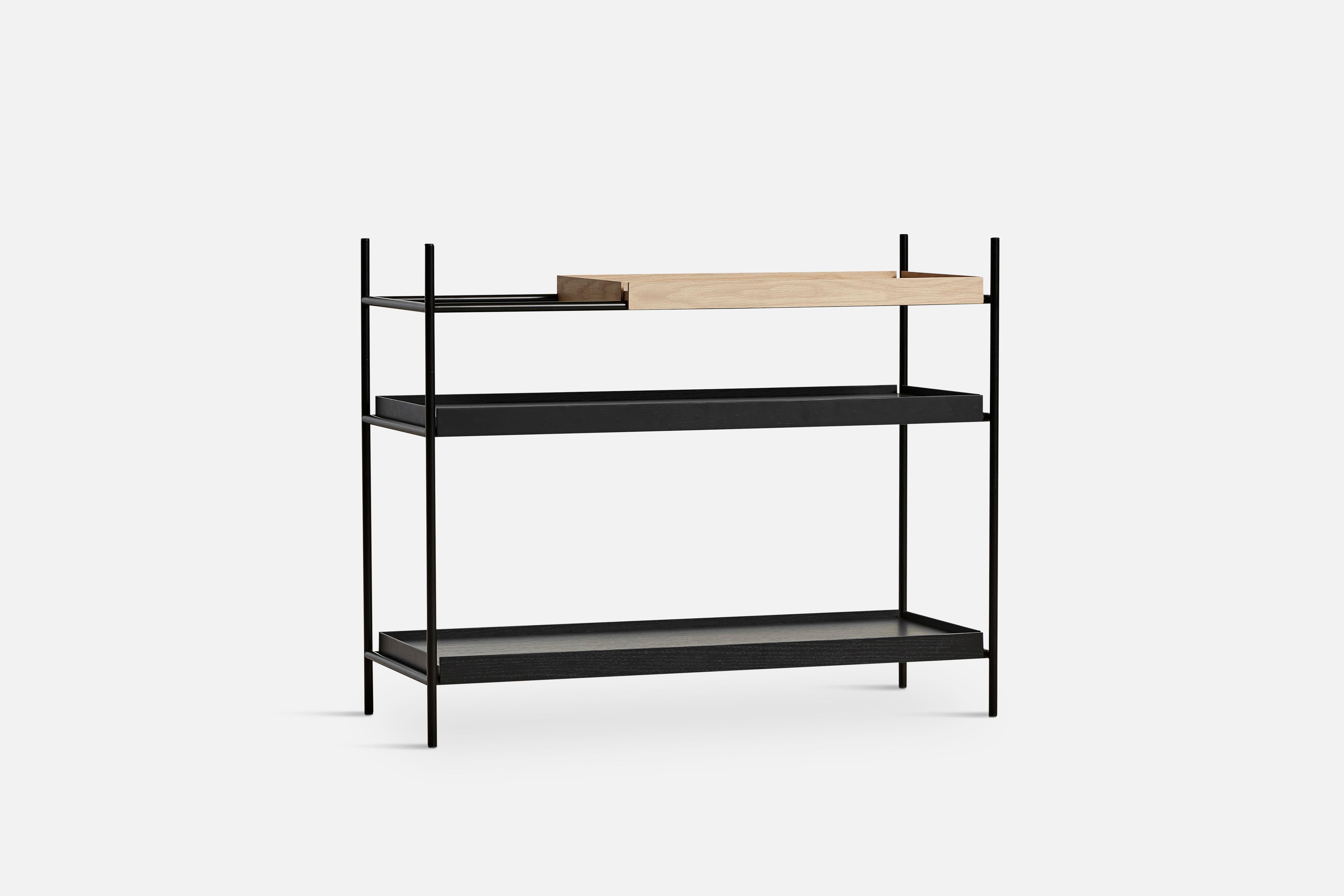 Low Oak and Black Tray shelf II by Hanne Willmann.
Materials: Metal, oak.
Dimensions: D 40 x W 100 x H 81 cm.
Also available in different tray conbinations and 2 sizes: H81, H 201 cm.

Hanne Willmann is a dynamic German designer with her own