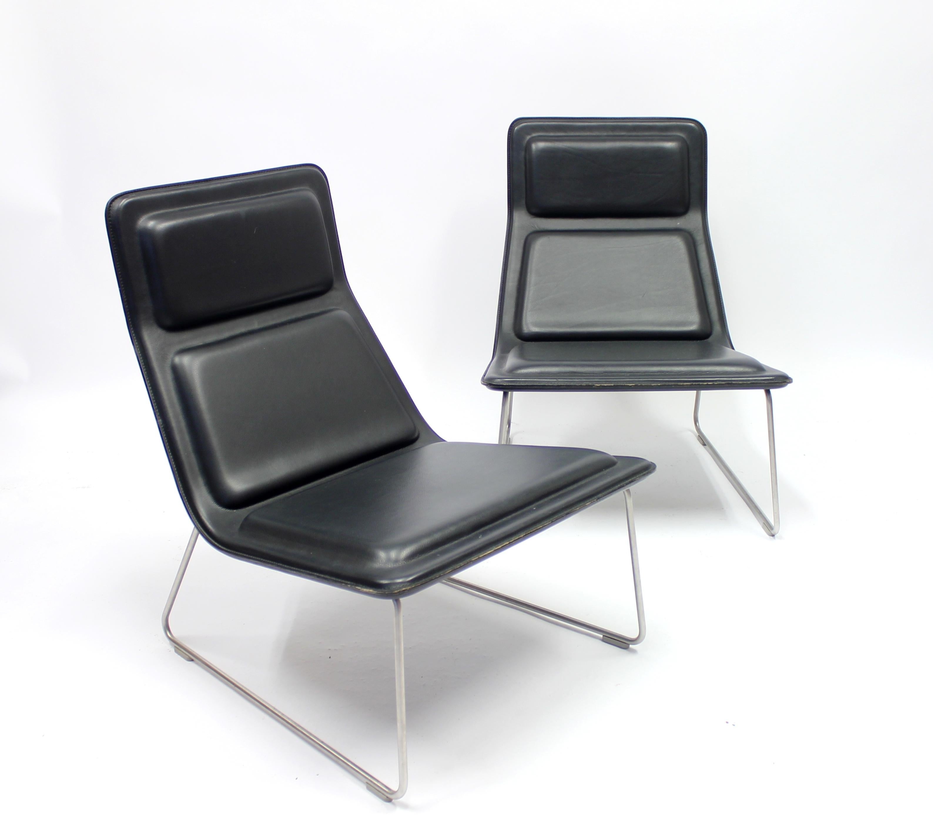 Pair of low pad easy chairs, designed by Jasper Morrison for Cappellini in 1999. Body in bent birch plywood, upholstered with multi-density polyurethane foam. Fixed cover in black leather. Frame is satin stainless steel, rubber feet. Morrison got