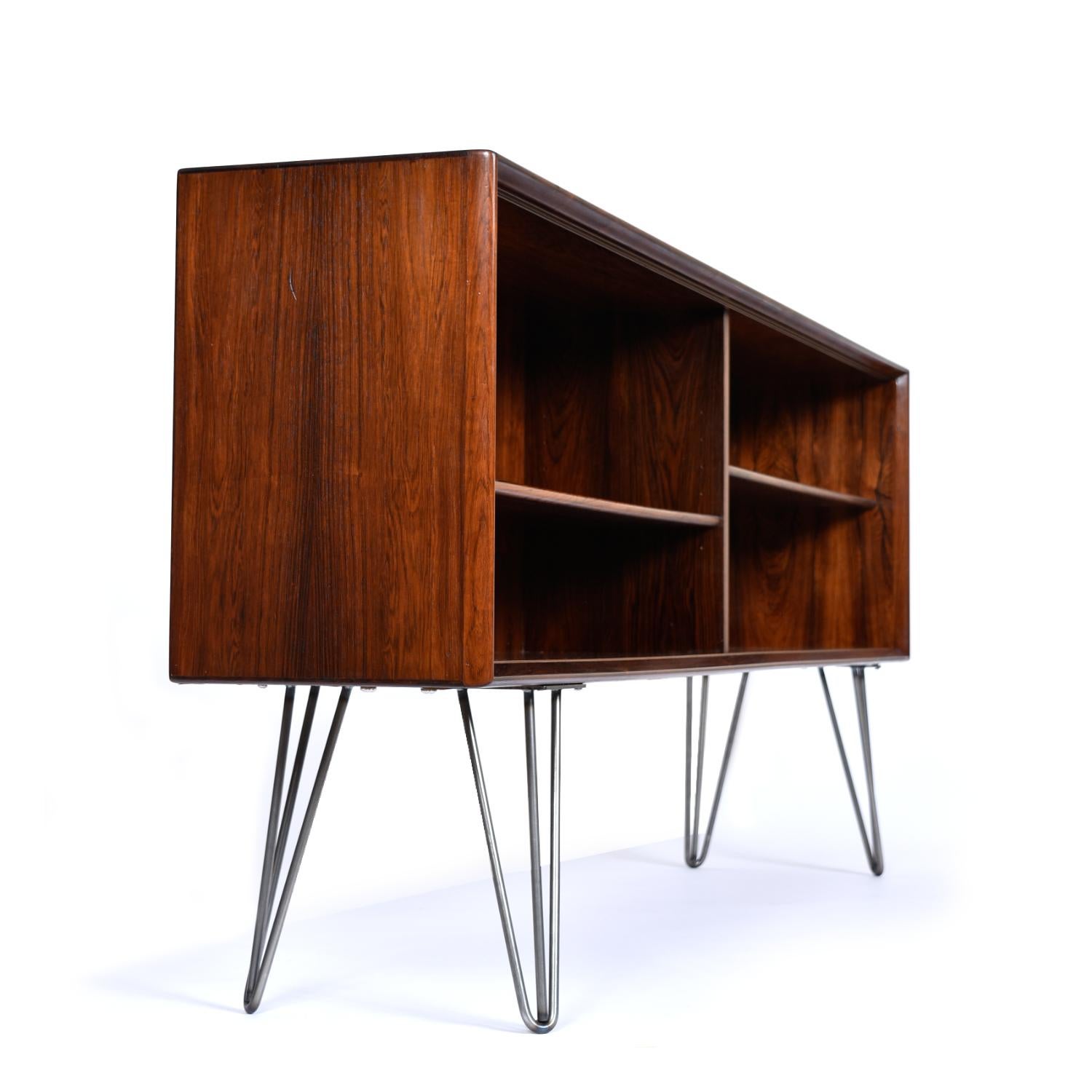Incredibly versatile Danish rosewood bookcase, vintage, 1960s. Rich, deep, oily luster on this old growth rosewood. This cabinet originally had glass doors (not included) and sat atop a buffet. Our team breathed new life into this orphaned gem by