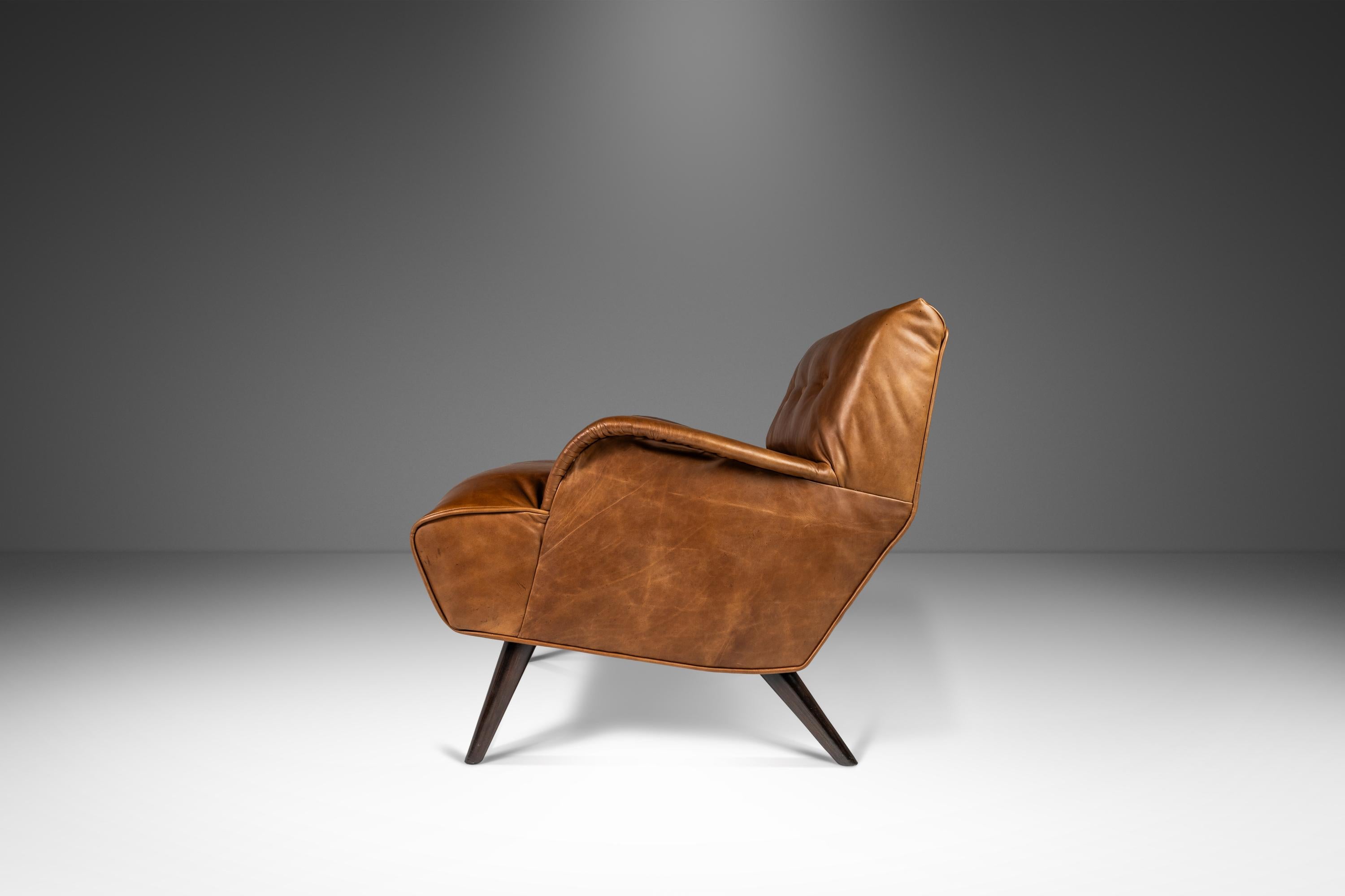 Simultaneously stylish and understated this exceptionally beautiful lounge chair, attributed to Carlo de Carli for Cassina, has recently undergone a comprehensive restoration process. Featuring newly upholstered genuine Italian leather, in a