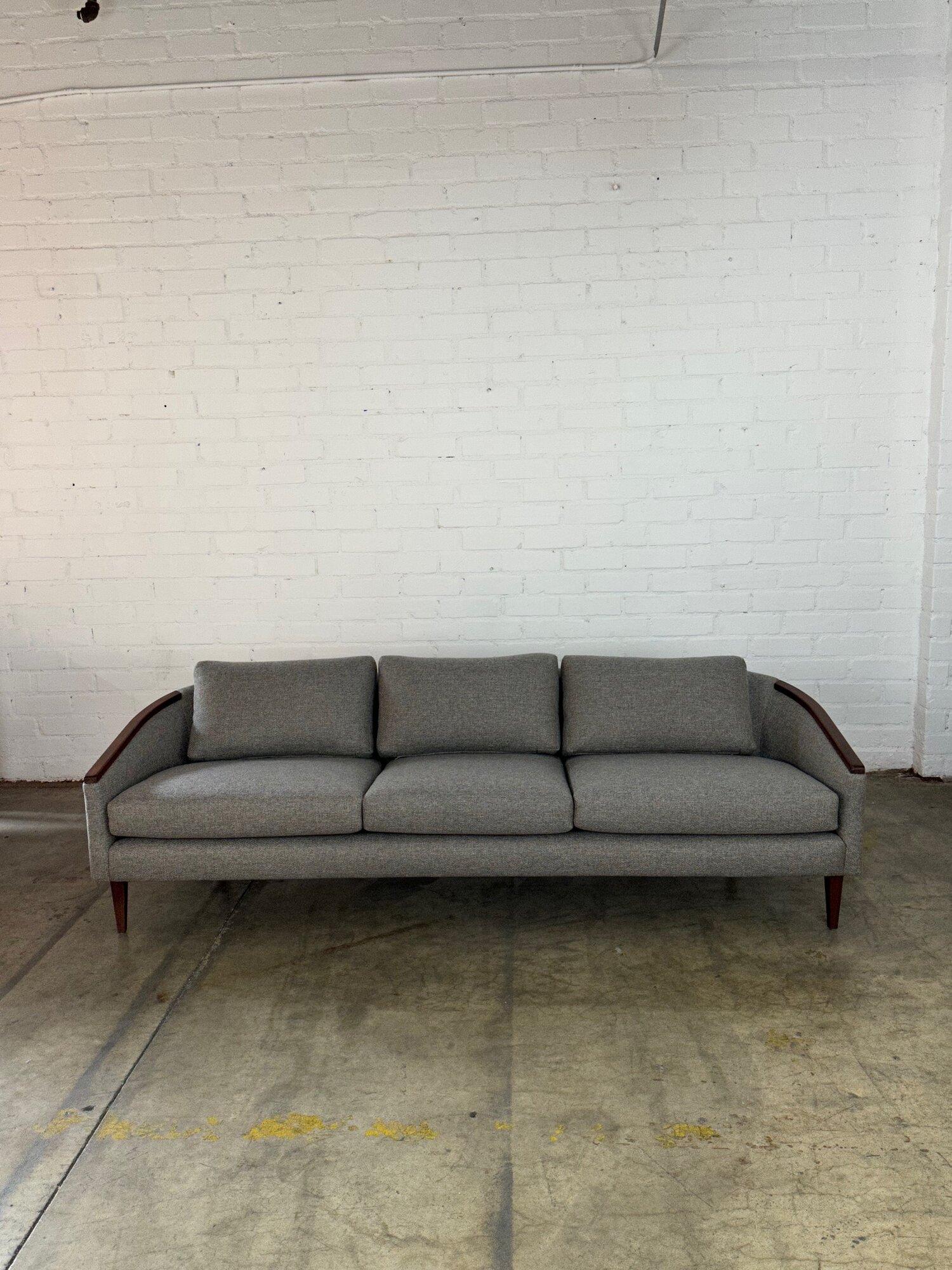 W91 D33 H25.5 SW84 SD18 SH18 AH21

Fully restored mid century low profile sofa. Item has a great barrel back curve, new foam and new soft tweed upholstery. Wooden surfaces are well preserved with no major areas of wear. Sofa is structurally sound