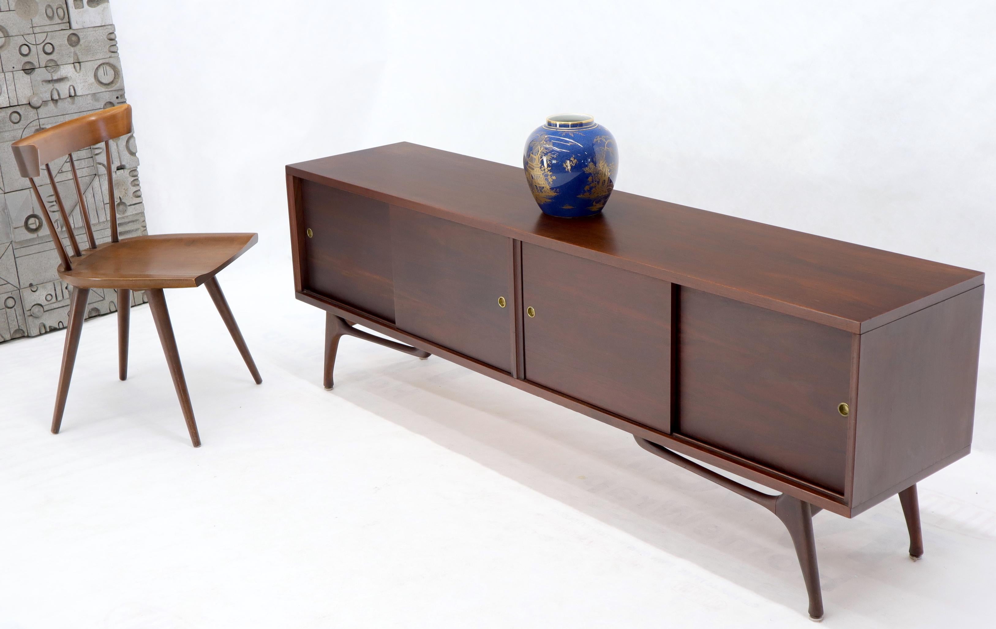 Mid-Century Modern oiled walnut finish sliding doors credenza. Standing on solid walnut sculptural legs. Excellent vintage condition. Perfect match for Kagan Pearsall decor.