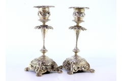 Low revealed silver candlesticks with applications on claw feet
