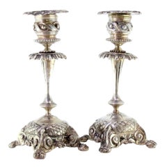 Low revealed silver candlesticks with applications on claw feet