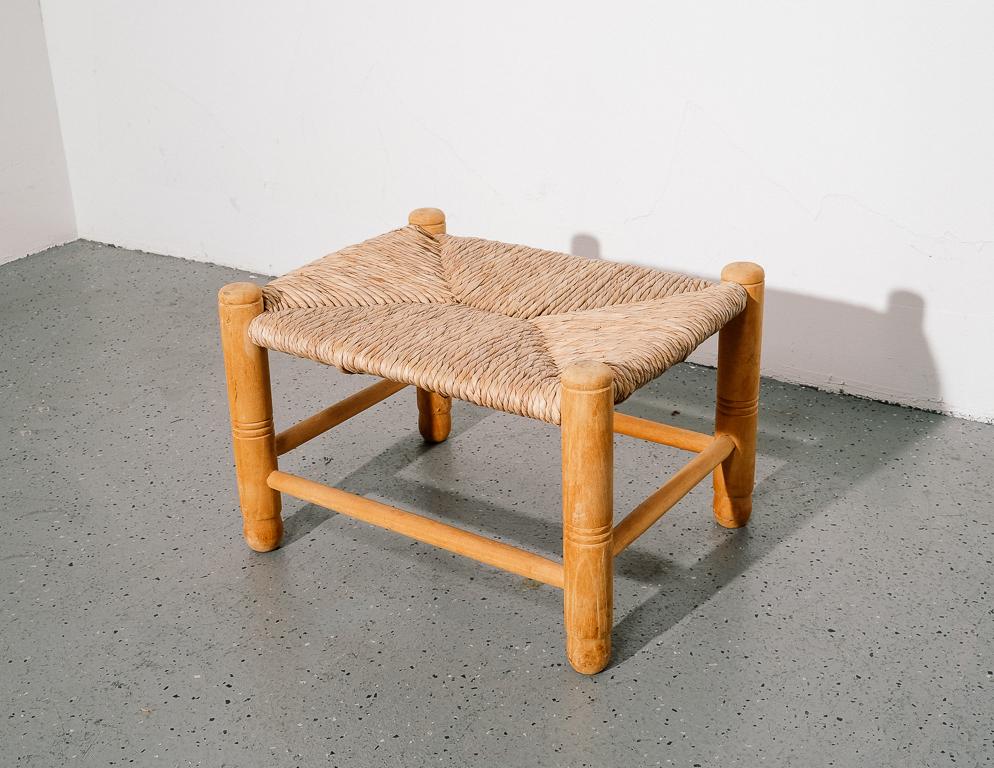 Vintage rush footstool in the style of Charlotte Perriand. Blonde wood frame with turned details.