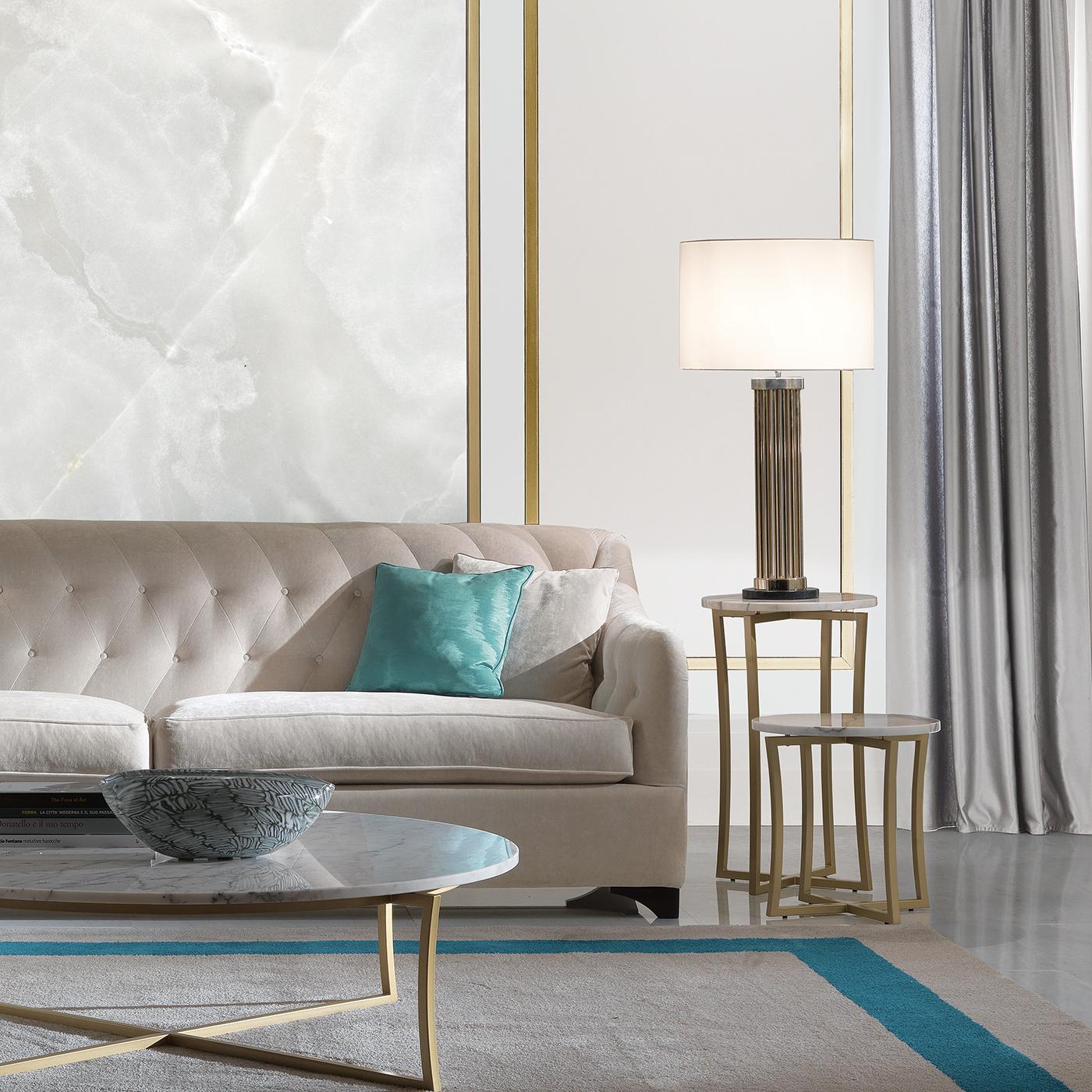 Part of a series of living room tables that pairs the luminous glow of brass with the sophisticated allure of Calcatta Oro marble, this low side table can be displayed alone to complement either a classic or a contemporary interior, or it can be