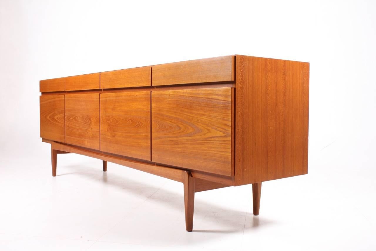 Great looking sideboard in teak designed by MAA. Ib Kofod-Larsen. Made by Faarup Møbelfabrik. Model no.66. Original condition.