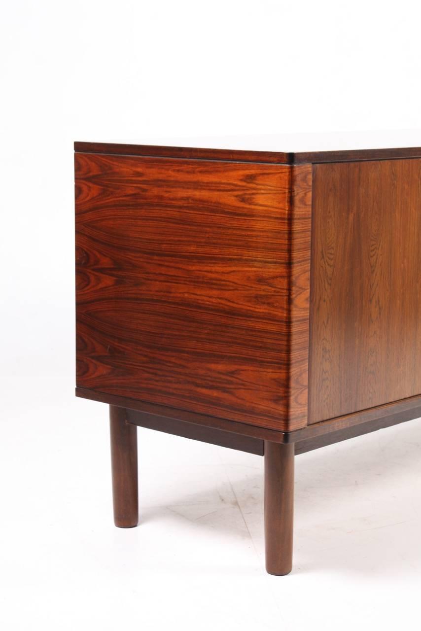 Great looking sideboard in rosewood with tambour doors, designed and made in Denmark. Great original condition.