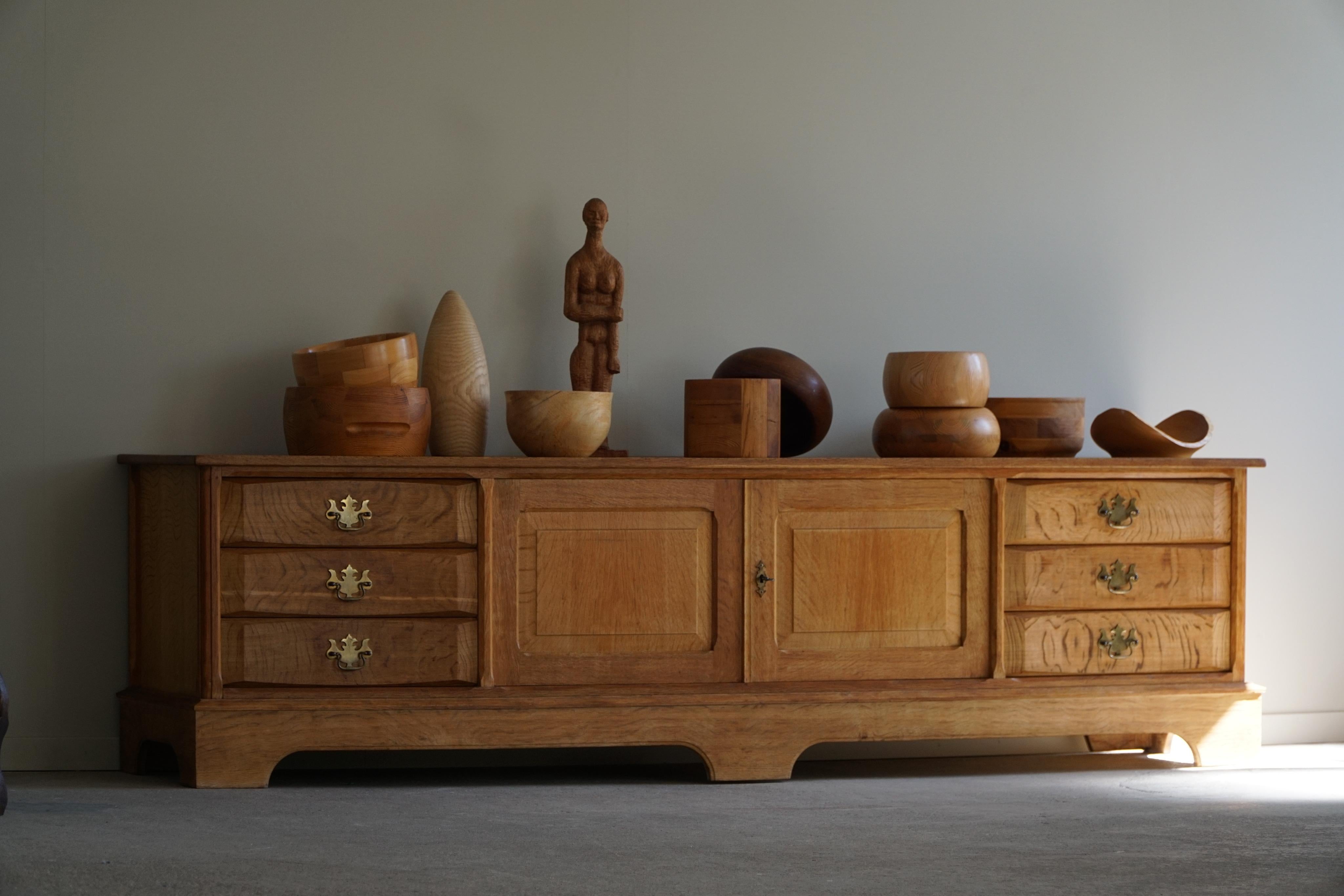 Introducing a timeless low sideboard crafted by a Danish cabinetmaker in the mid-century era of the 1960s. This elegant and functional piece embodies the Scandinavian design principles of simplicity, functionality, and natural materials, making it