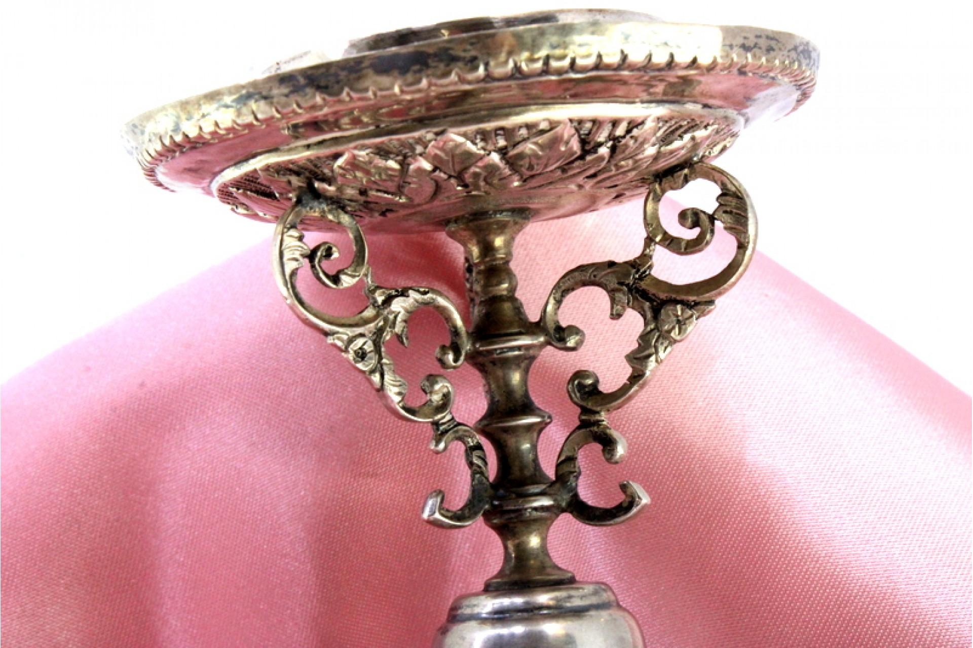 Silver Low silver candlestick with relief engravings on round base with three legs For Sale