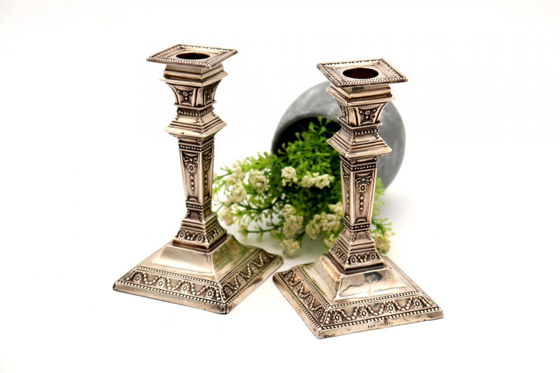 20th Century Low silver candlesticks w/ embossed columns, stems & bases w/ pearly friezes For Sale