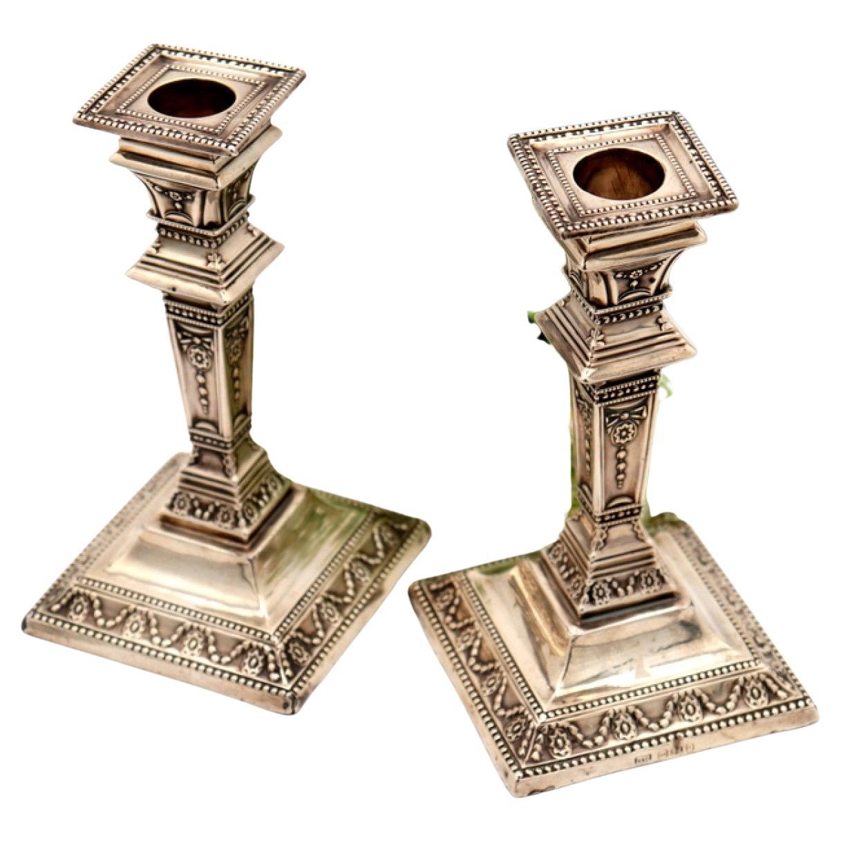 Low silver candlesticks w/ embossed columns, stems 
bases w/ pearly friezes For Sale