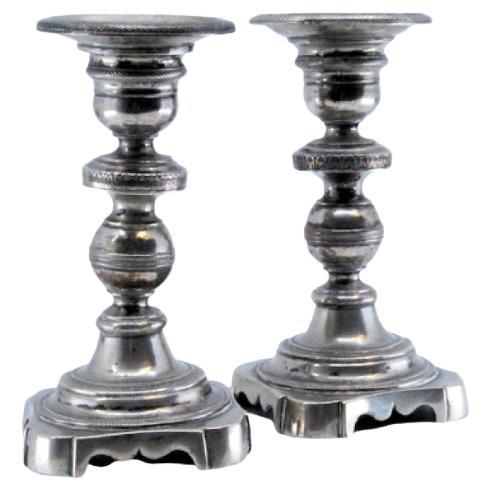 Low silver candlesticks with turned stems and friezes on the cut-out bases For Sale