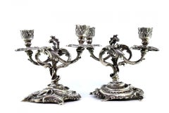 Low silver two-light candelabra with shells, garlands and cut-out bases