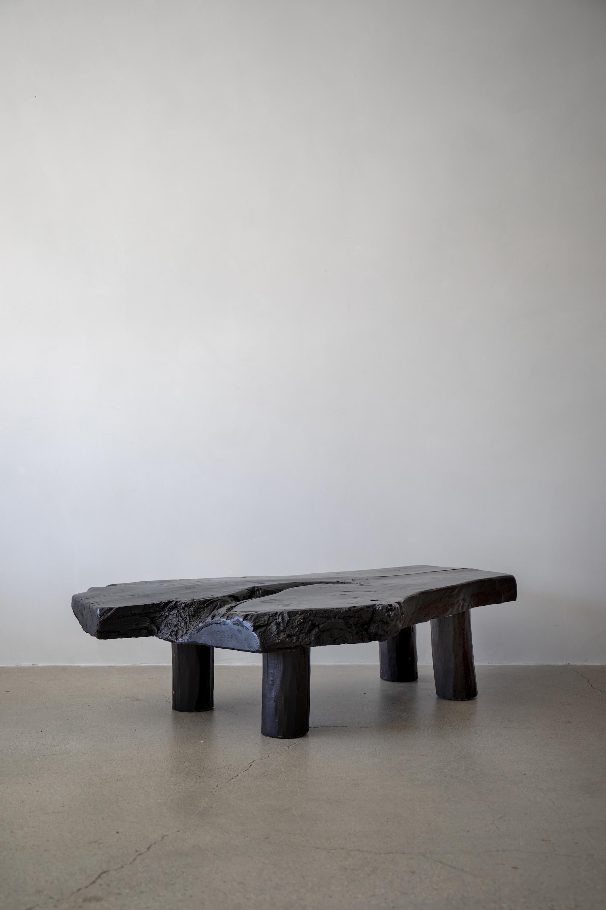 France, 1970s

Wood slab top with mortise and tenon joinery and pole legs in multi-layered black finish. Rustic yet refined coffee table.

Condition - wear consistent with age.

