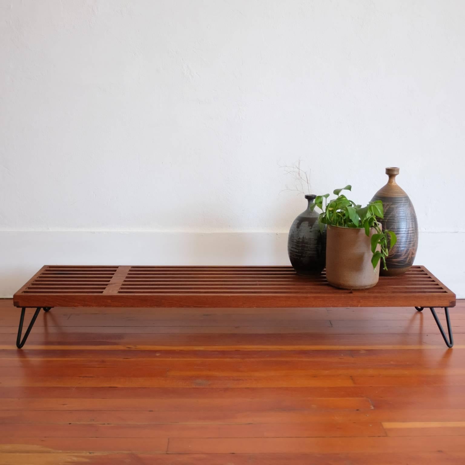 Slatted wood display tables with iron legs from the 1950s. Japanese-influenced design. The low long table was used for a television by the original owner. They can be used as stands or plinths to display art, ceramics or plants. Solid wood