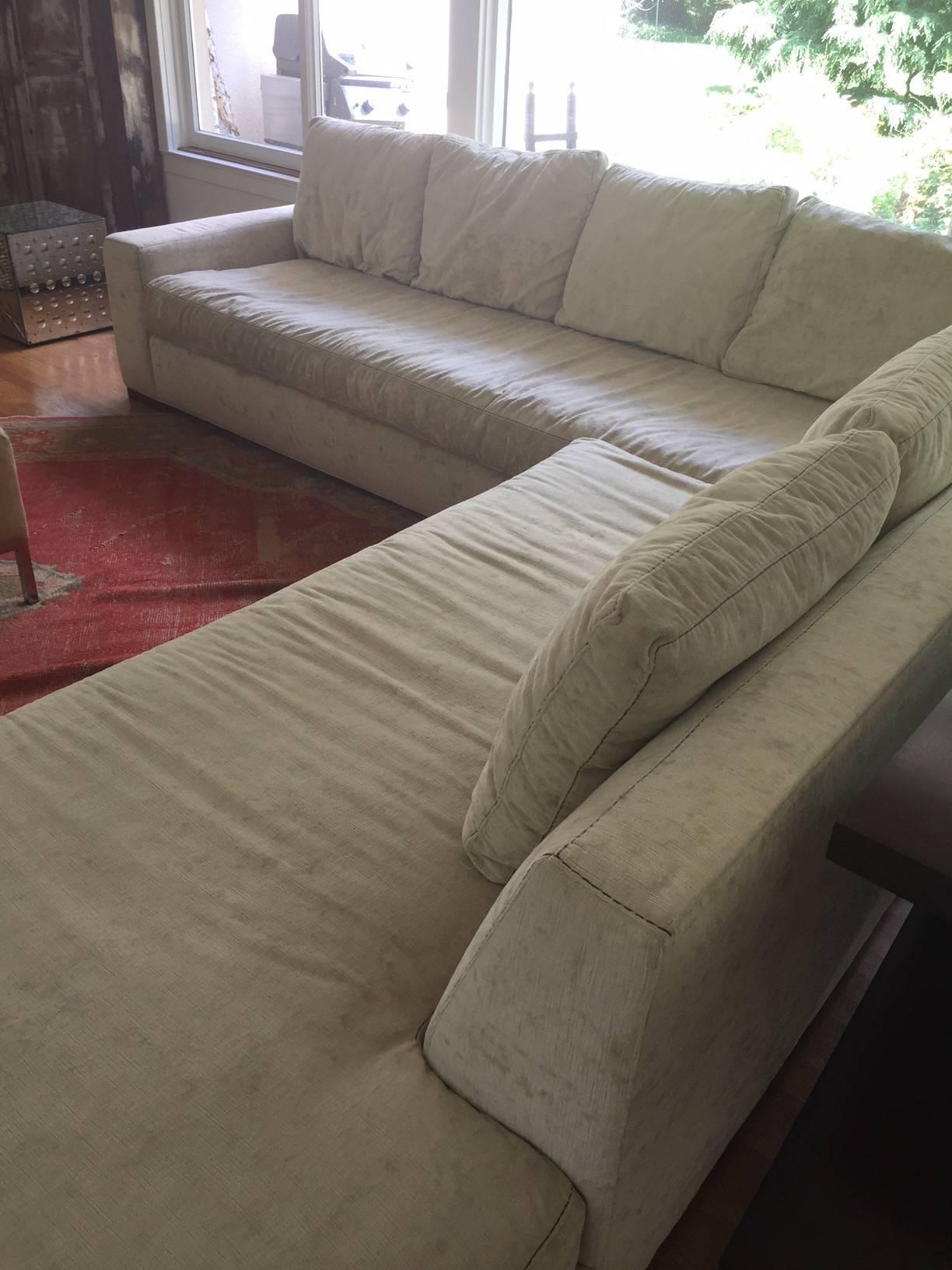 Sophisticated and super comfy very large sexy off white section sofa upholstered in a micro fiber fabric with the look and feel of velour. Incredibly resilient to stains and cleans easily. Was just professionally cleaned and in beautiful shape.