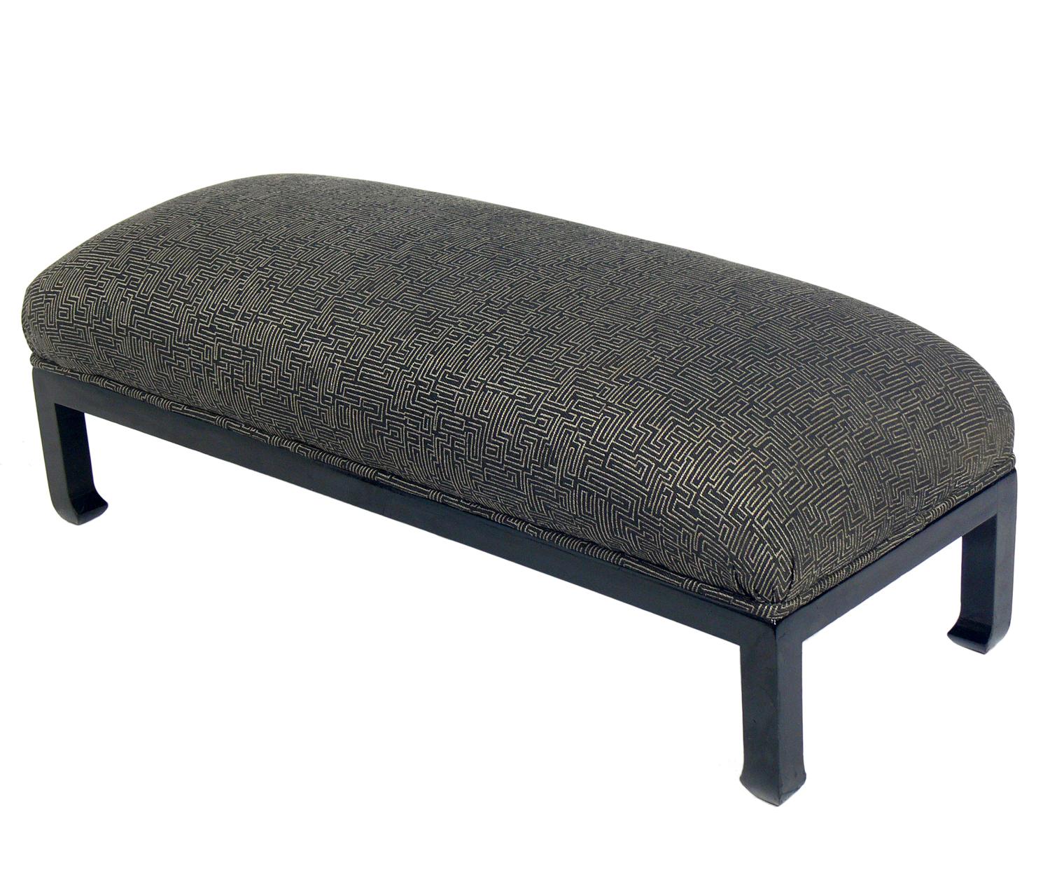 Low Slung Asian inspired midcentury bench, American, circa 1950s. This piece was probably reupholstered in it's Asian style geometric fabric within the past few years. Black lacquered base appears to be the original finish.