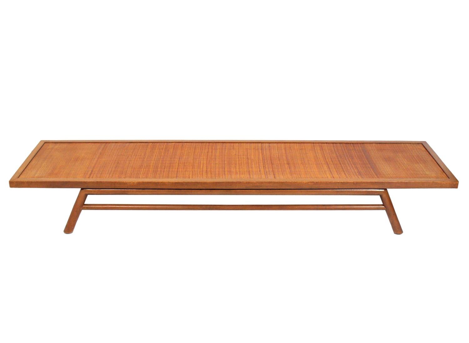 Low slung coffee table or bench, designed by T.H. Robsjohn-Gibbings for Widdicomb, American, circa 1950s. As you can see in the last period photo, Gibbings seems to have preferred it as a bench. We can make a cushion for this in your fabric for an