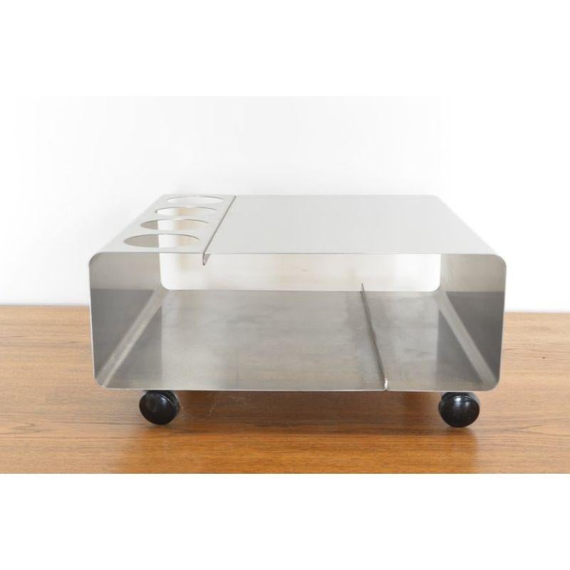 Low steel bar table on wheels in the style of Joelle Ferlande and Francois Monnet, 1970's

Materials: Curved stainless steel and moveable on four original wheels. Character enhanced by patina and wear.

Approx Dimensions: 19