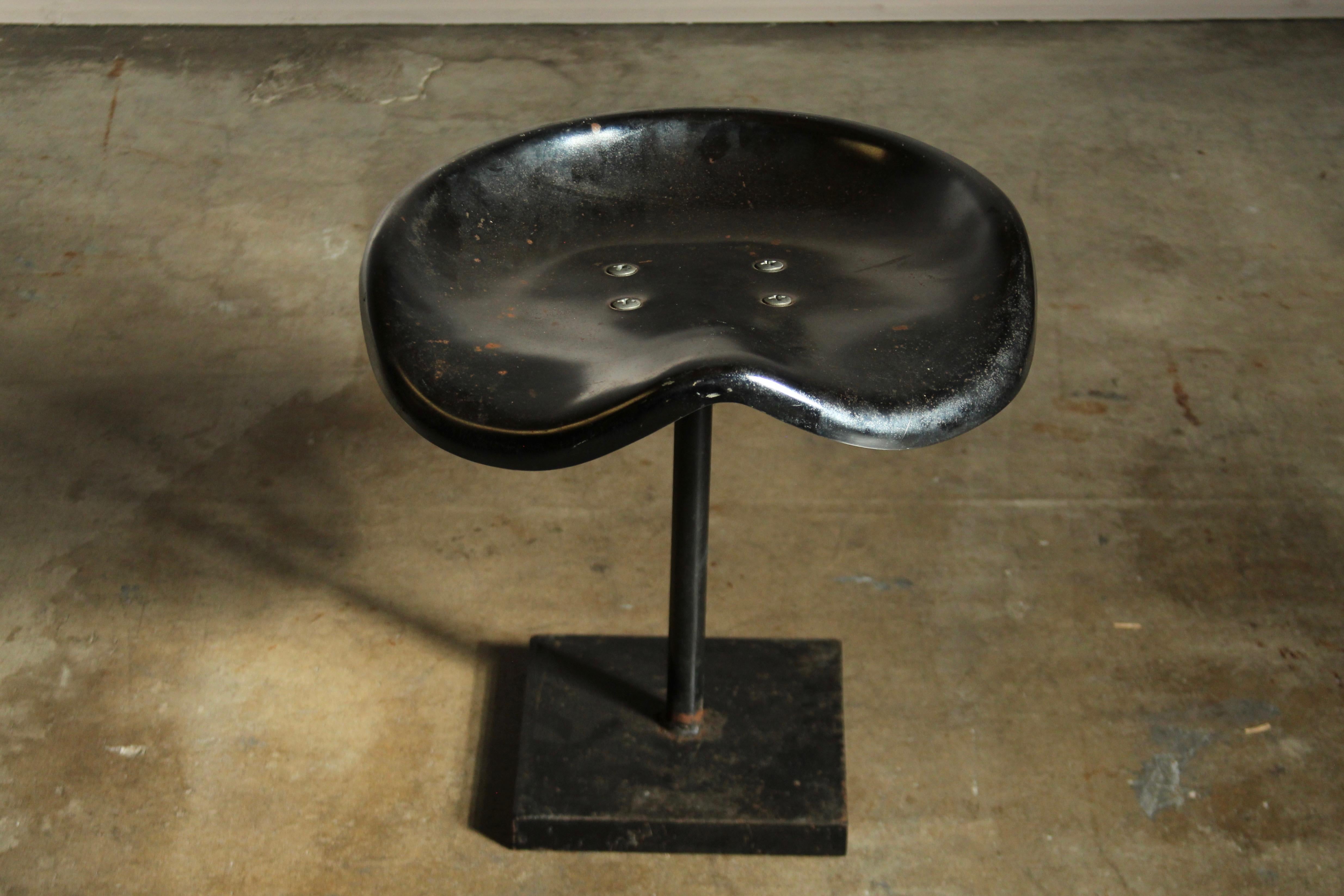 A totally unique, one-of-a-kind, artisan crafted stool featuring a chromed metal tractor seat and a heavy duty steel base. Total Jean Prouve vibes. Incredibly sturdy. Great vintage condition with age consistent patina throughout, including some