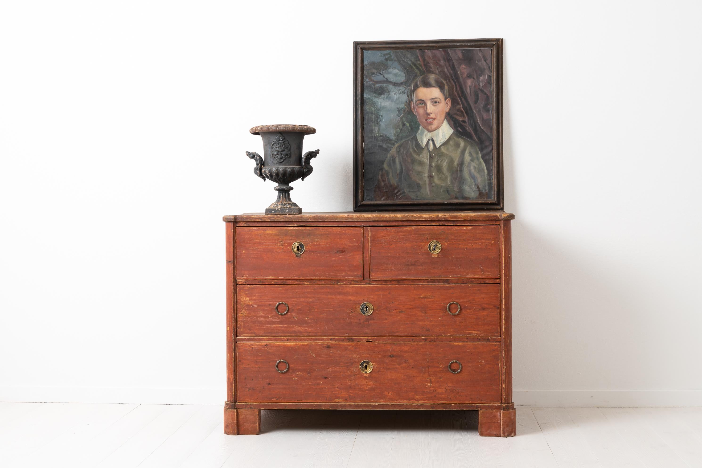Swedish Gustavian chest of drawers from the neoclassical period. The chest is quite low and only 82 cm tall with four drawers divided on three levels. Old historic red paint with some natural marks and a patina of time. After being in use for over