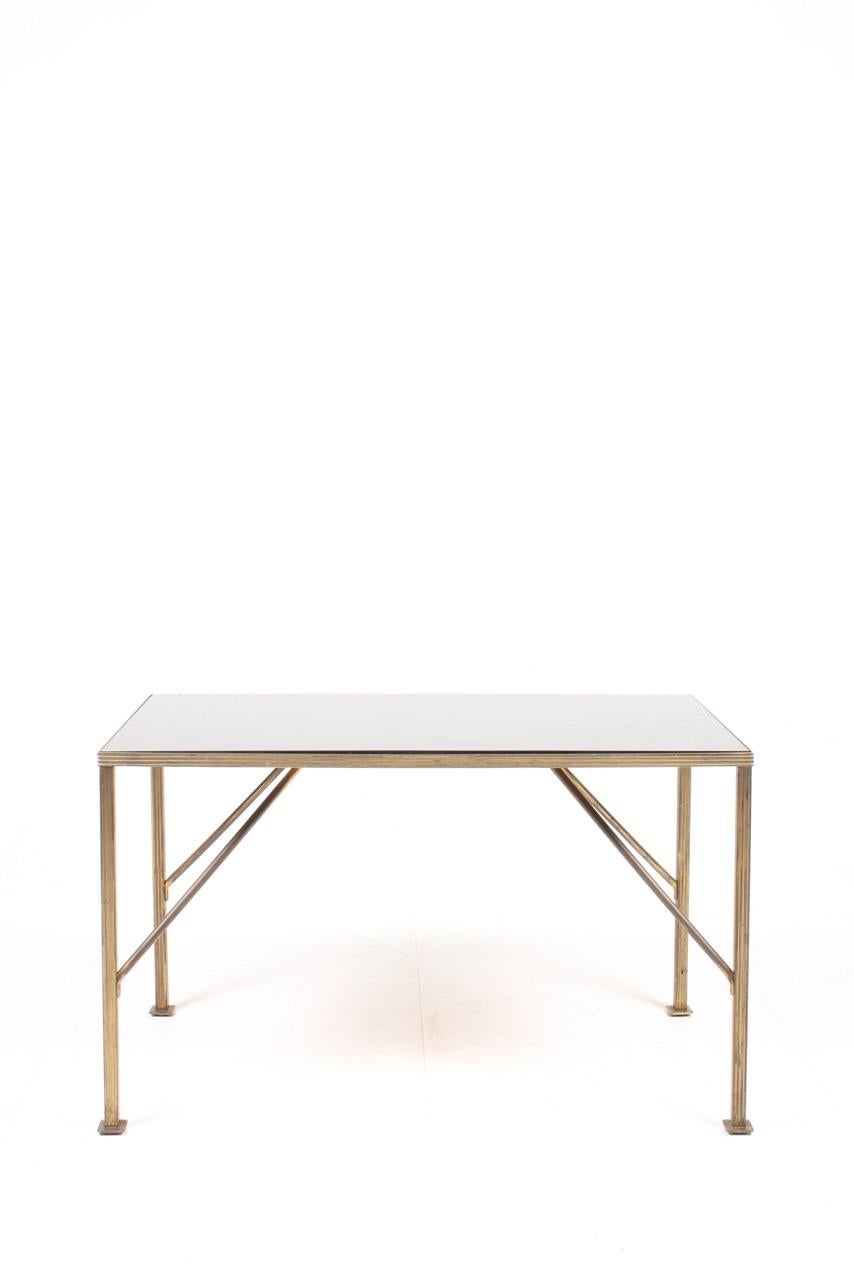 Low table in brass with glass top made by ysberg Hansen & Terp. Made in Denmark, circa 1940. Great original condition.
