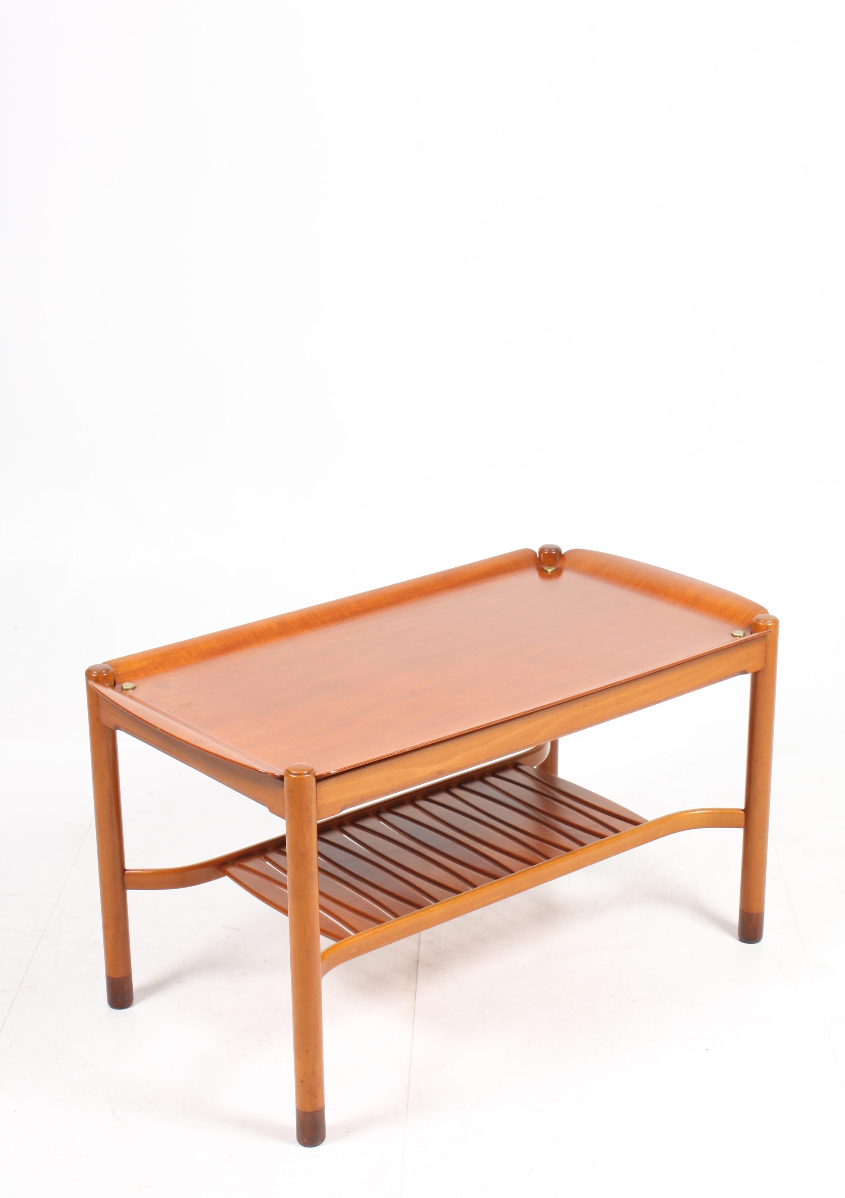 Small low table in mahogany designed by David Rosen for Nordiska Kompaniet cabinetmakers. Made in Sweden in the 1950s. Great original condition.