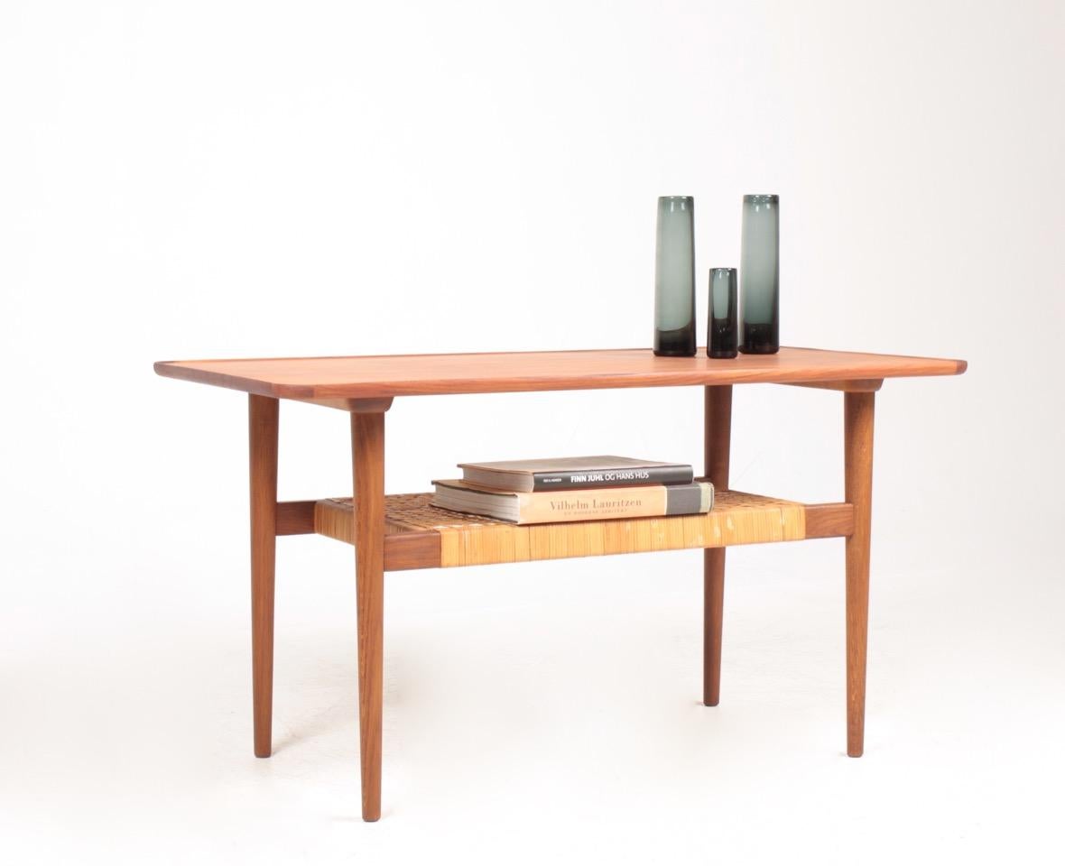 Low table in teak, oak and cane. Designed made in Denmark, 1950s. Original condition.